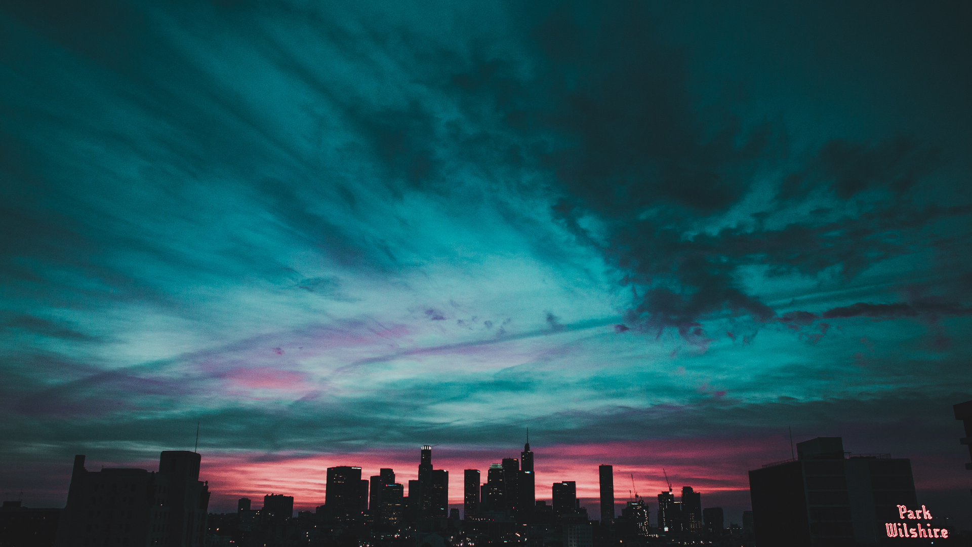 Cityscape at Dusk with Dramatic Clouds HD Wallpaper