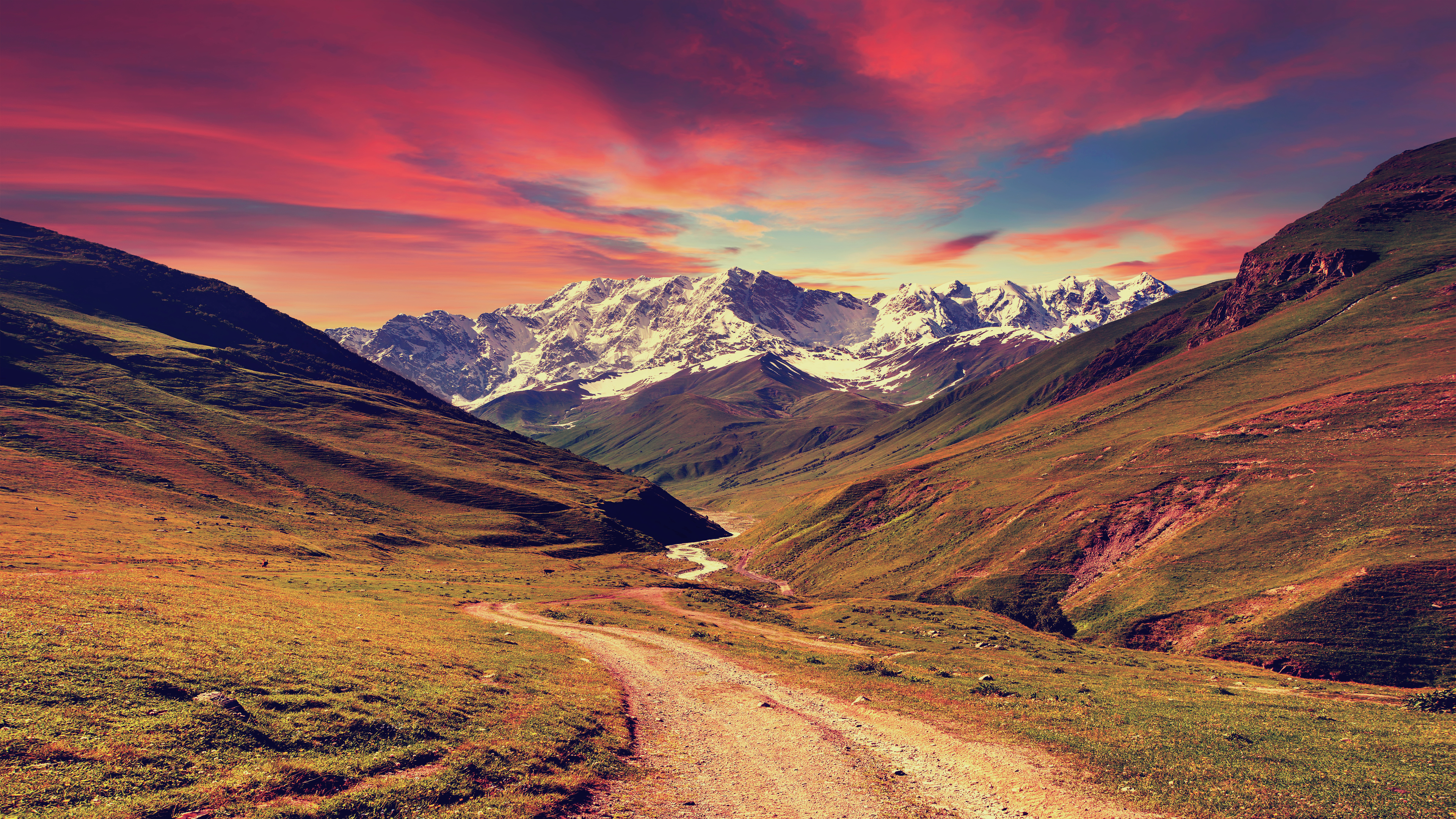 Mountain valley with a dirt road at sunset HD Wallpaper