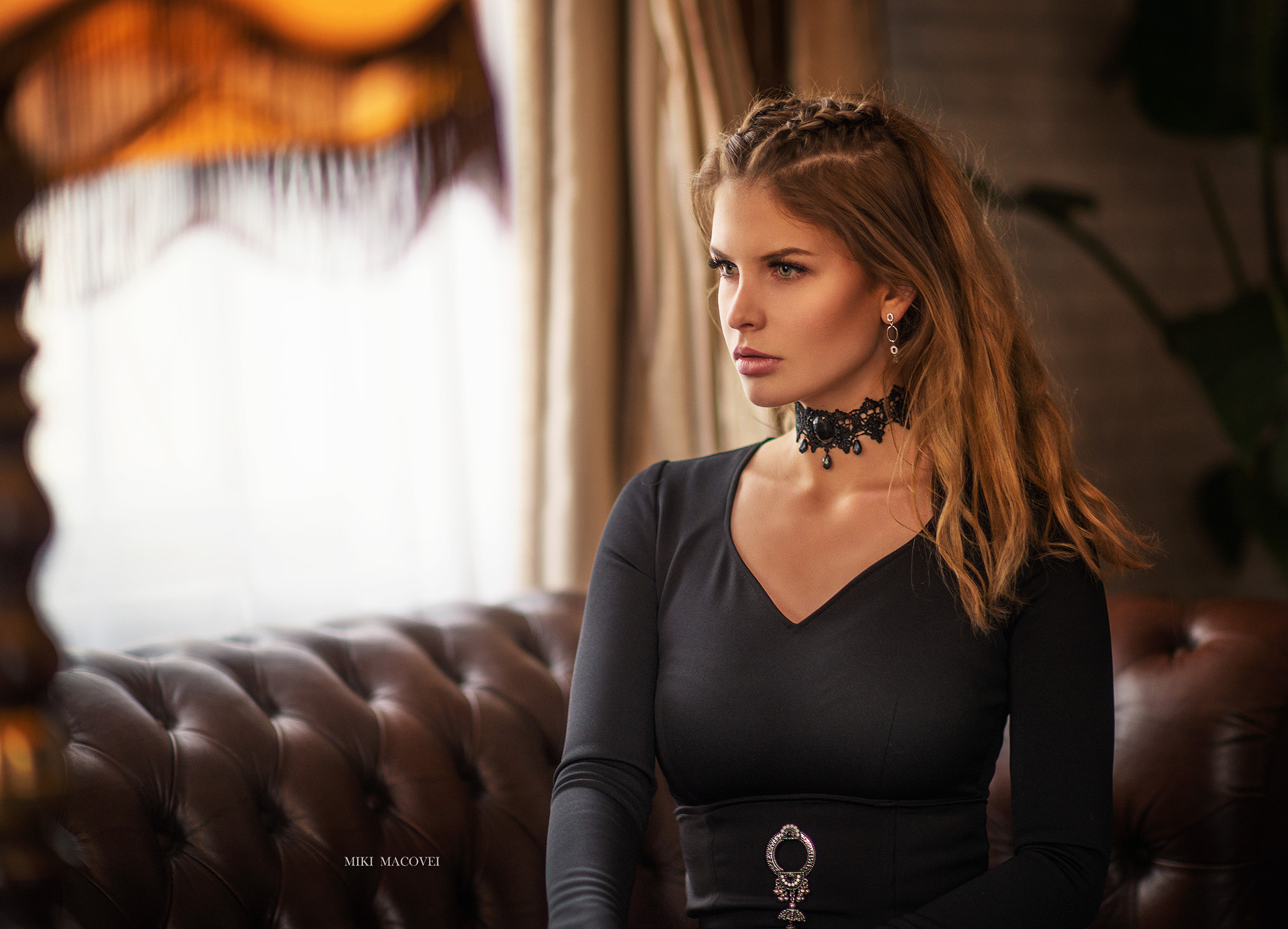 Woman with braided hair and choker sitting on a couch HD Wallpaper