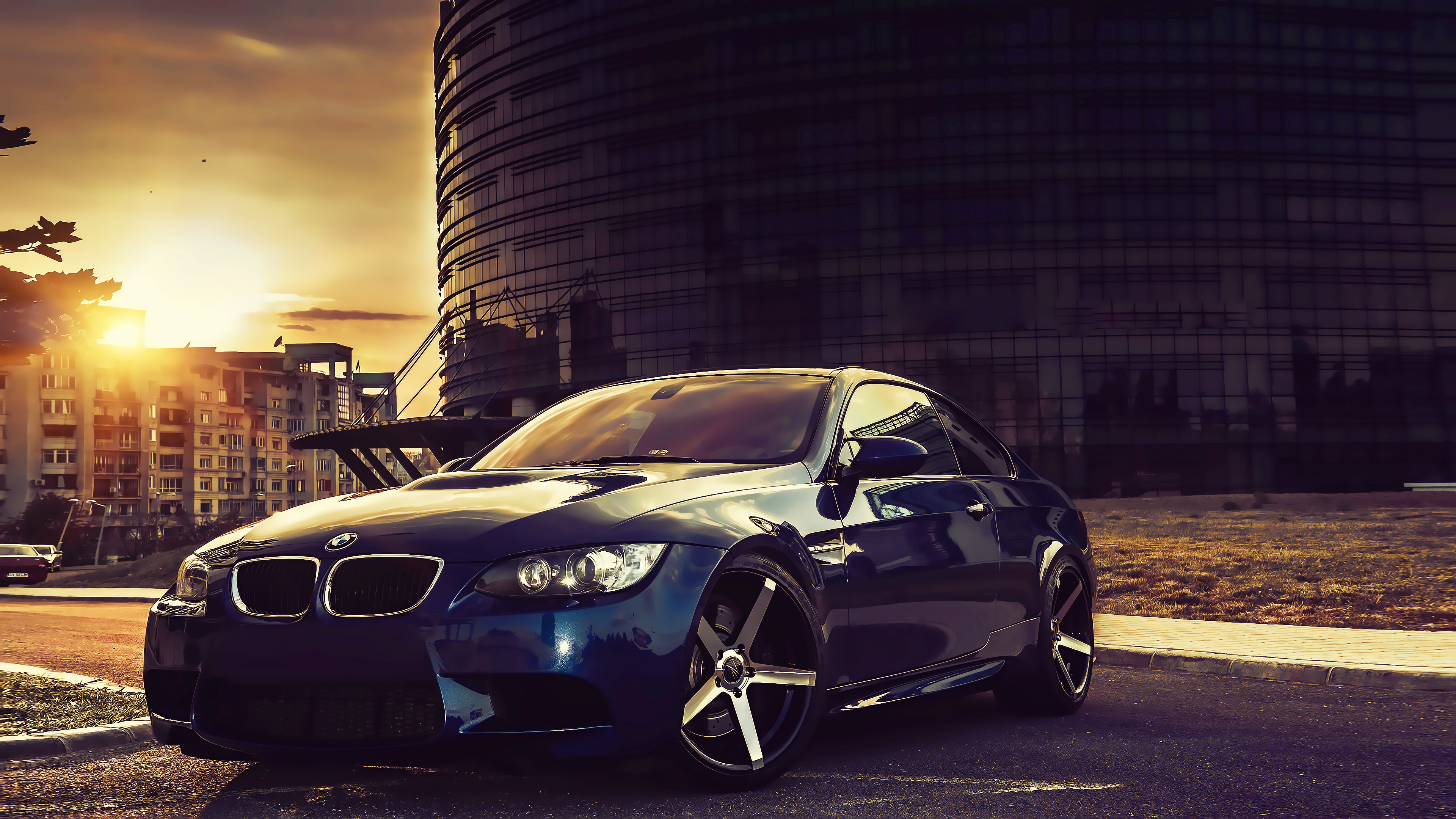 Blue BMW M3 Coupe parked in a city at sunset HD Wallpaper