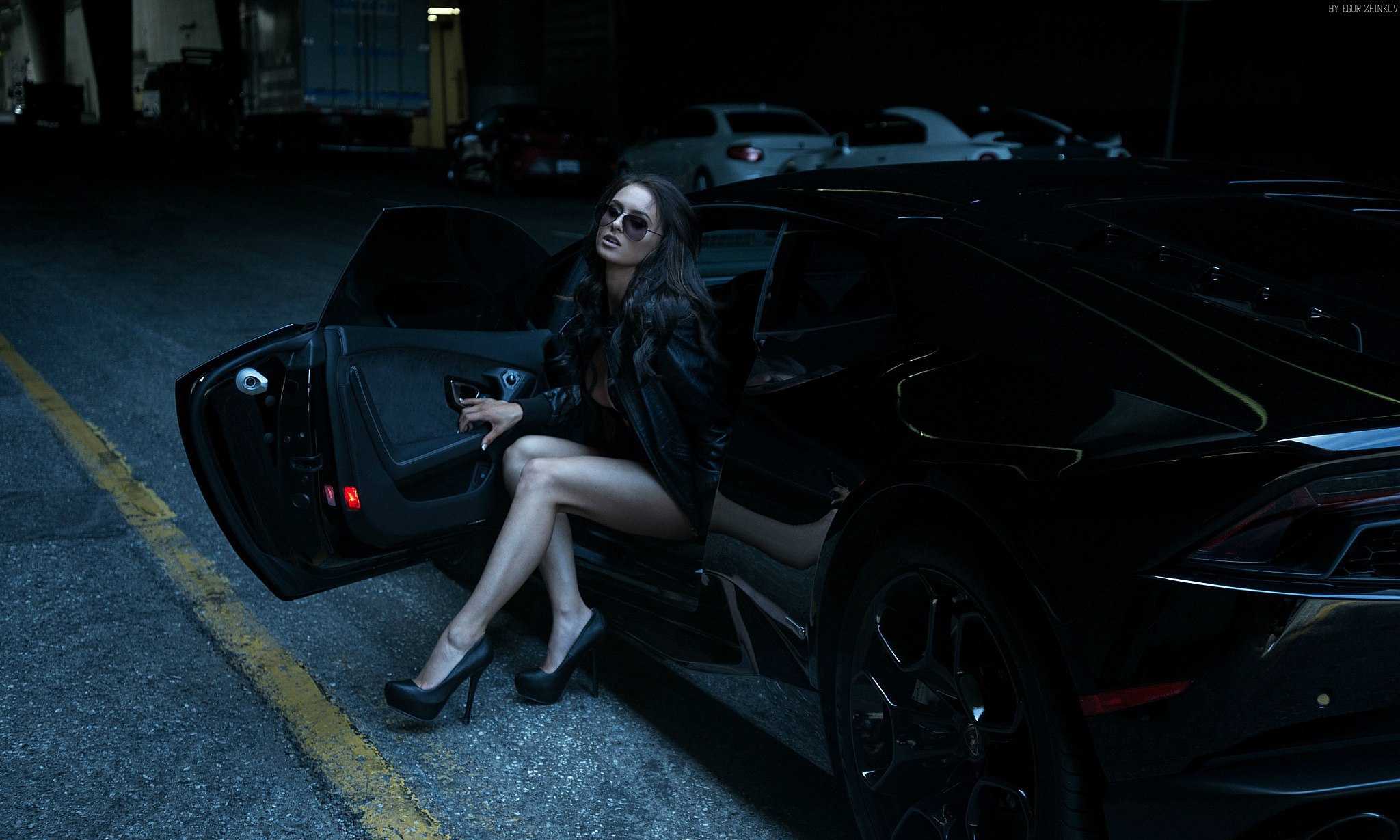 Woman in leather jacket and heels posing with Lamborghini Huracan HD Wallpaper