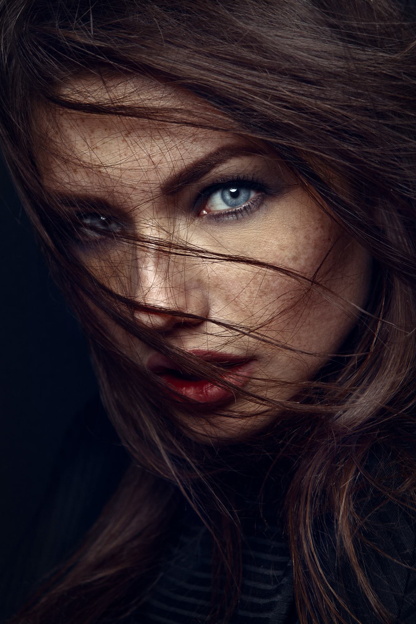 Woman with freckles and blue eyes, hair blowing HD Wallpaper