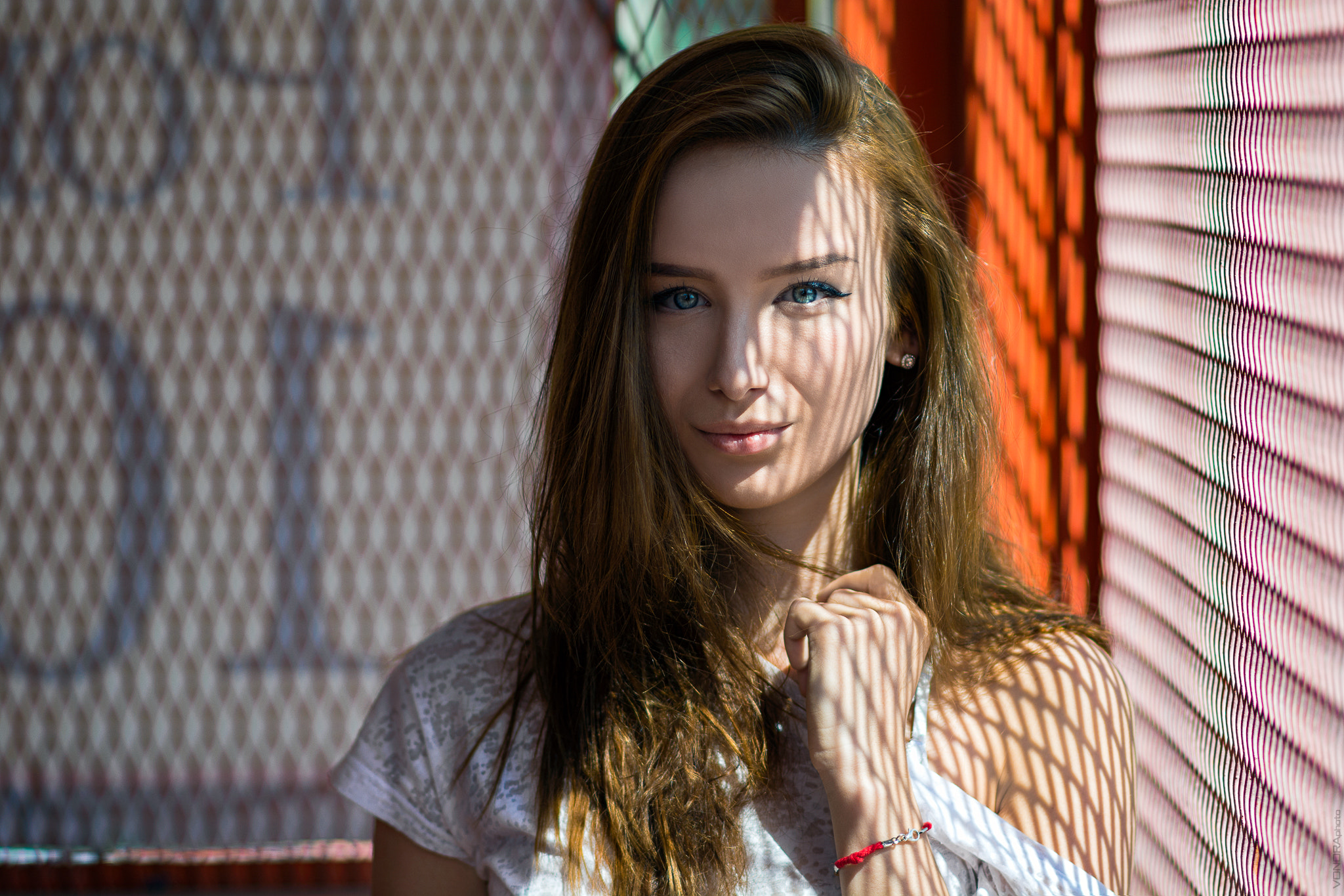 Woman with blue eyes and shadows on her face HD Wallpaper