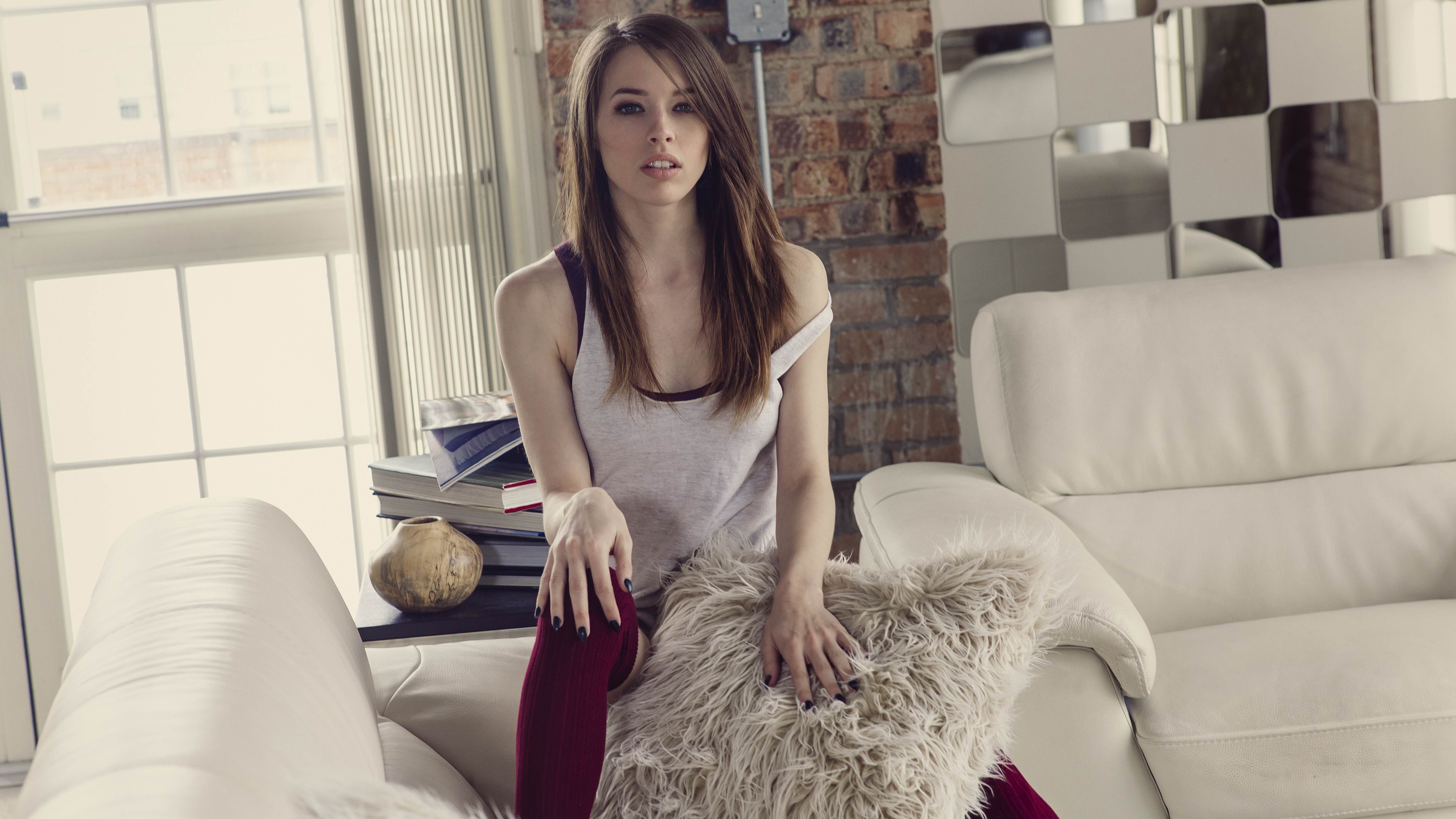 Caitlin McSwain sitting on a couch indoors HD Wallpaper