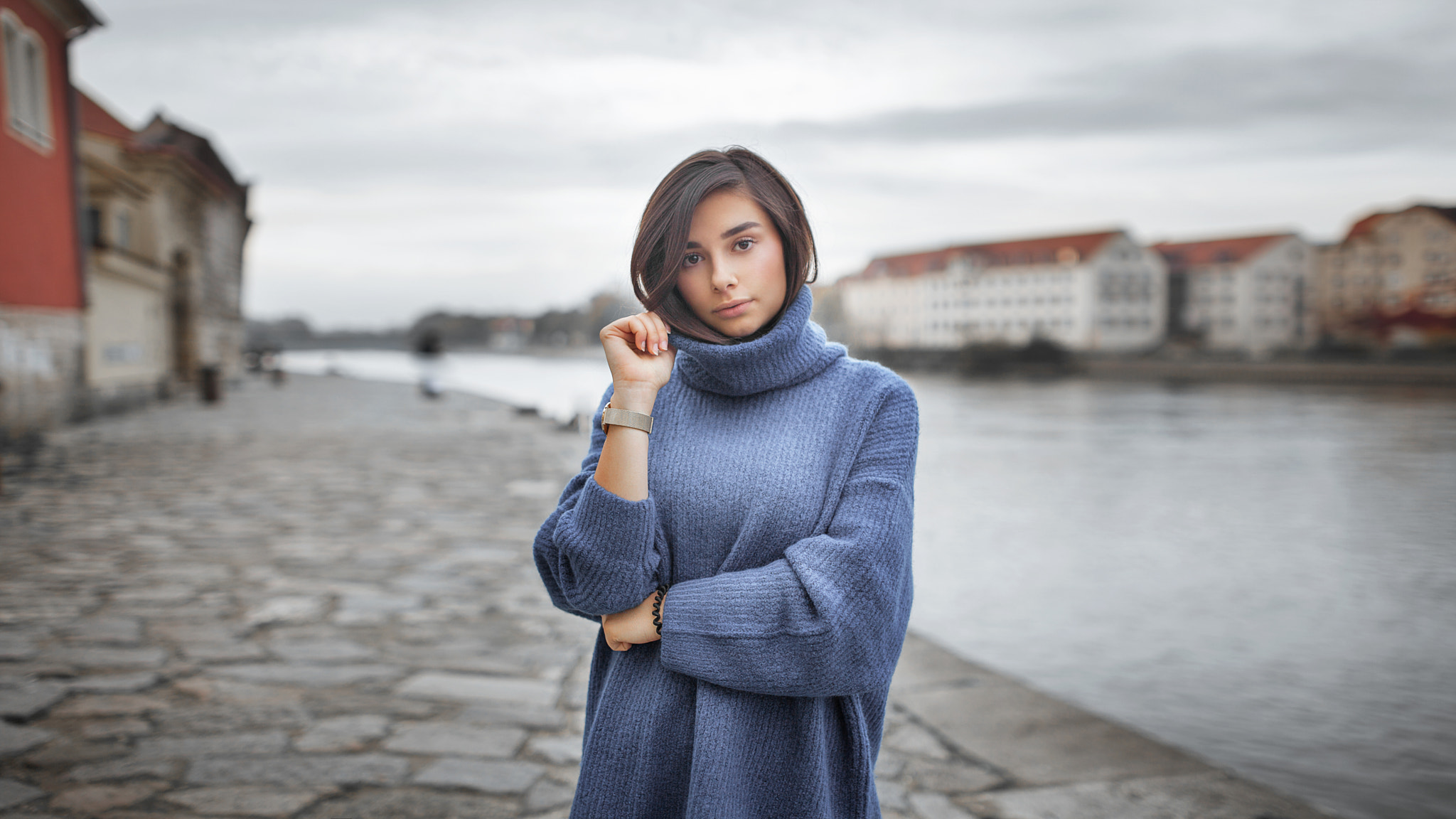 Woman in turtleneck sweater by river HD Wallpaper