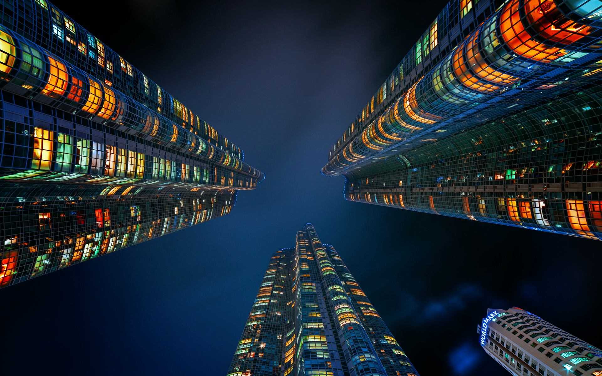 Skyscrapers at night with illuminated windows HD Wallpaper