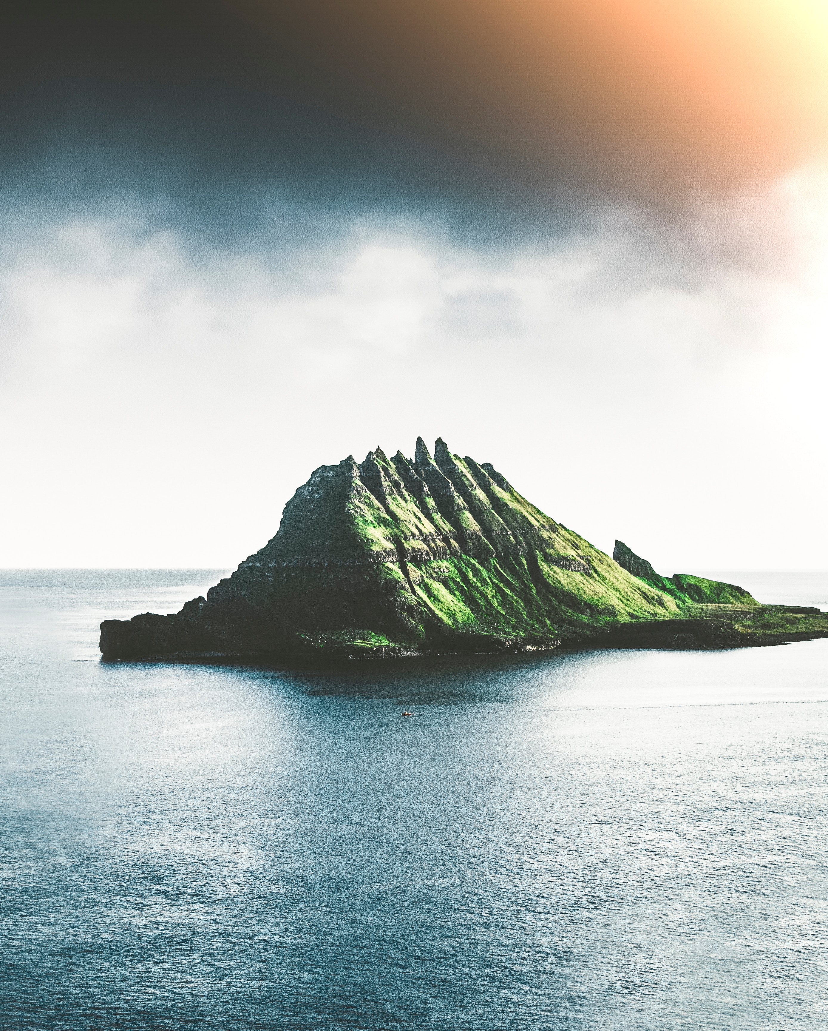 Island in the ocean with dramatic clouds HD Wallpaper