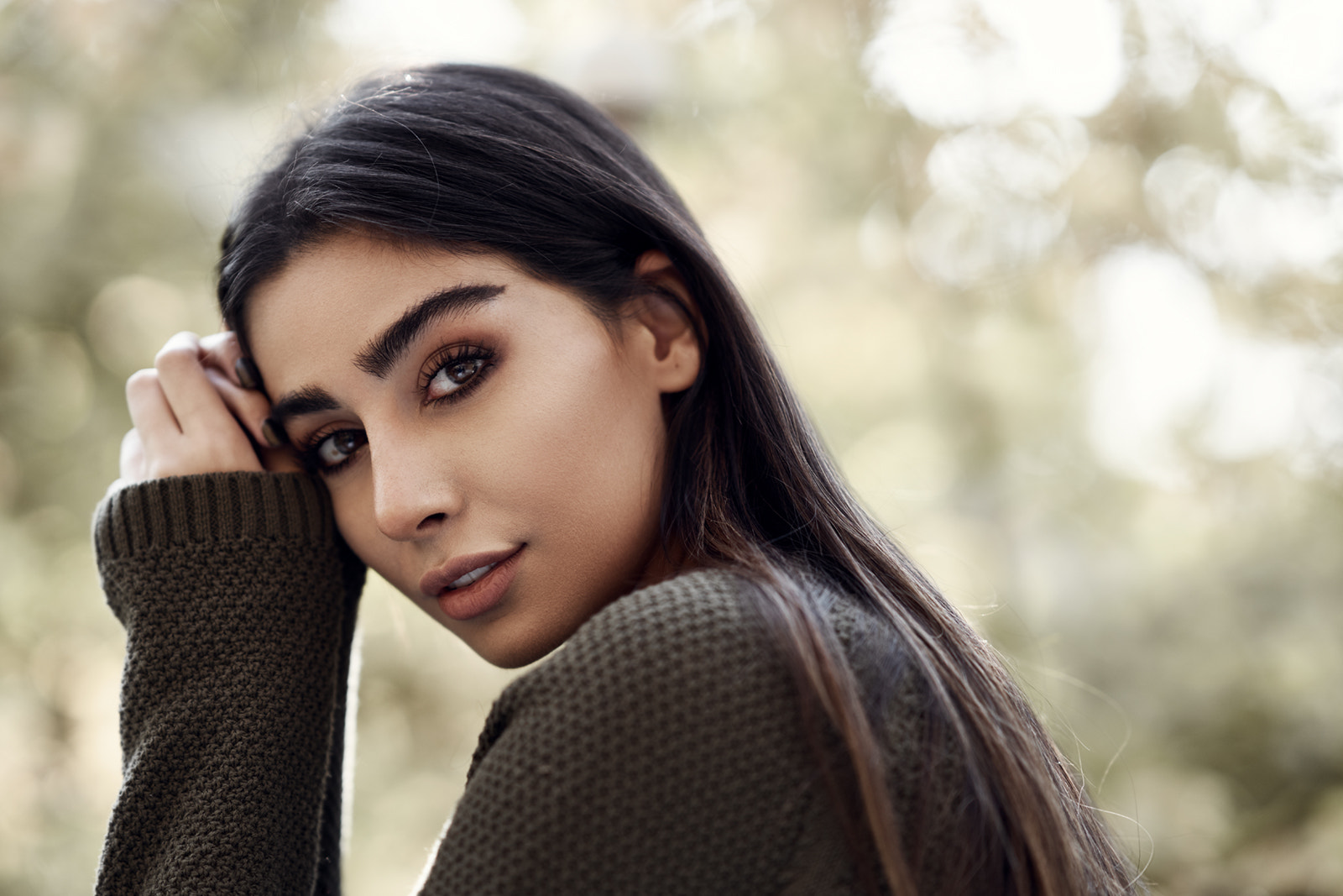 Woman with dark hair in a green sweater HD Wallpaper