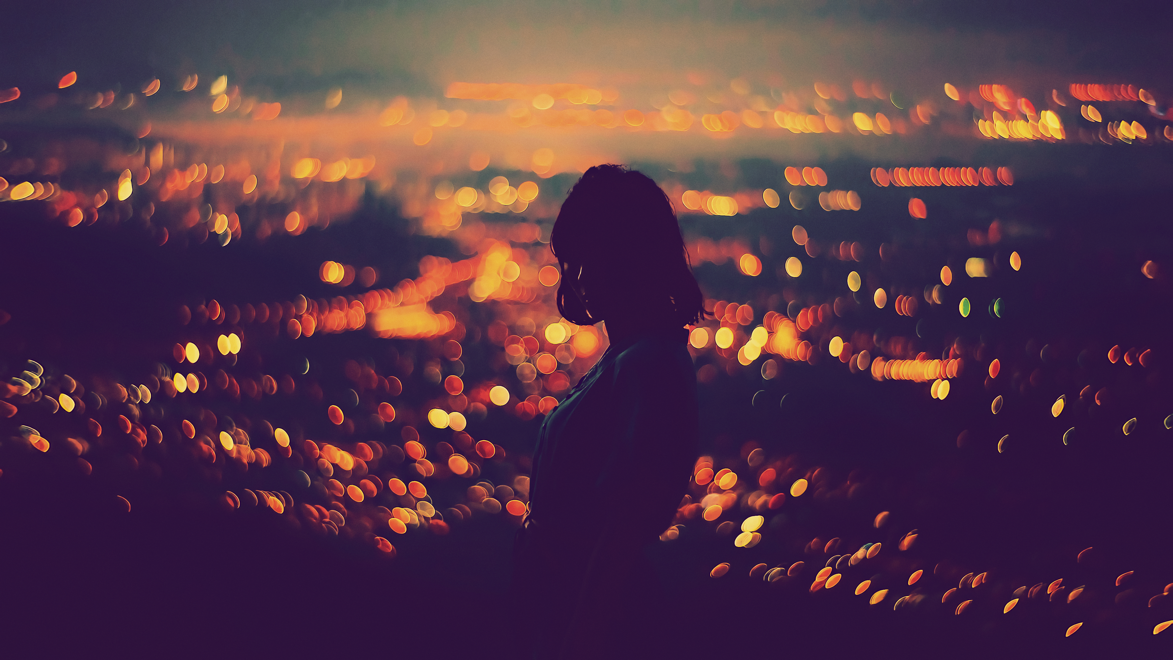 Silhouette of a woman against bokeh city lights at night HD Wallpaper