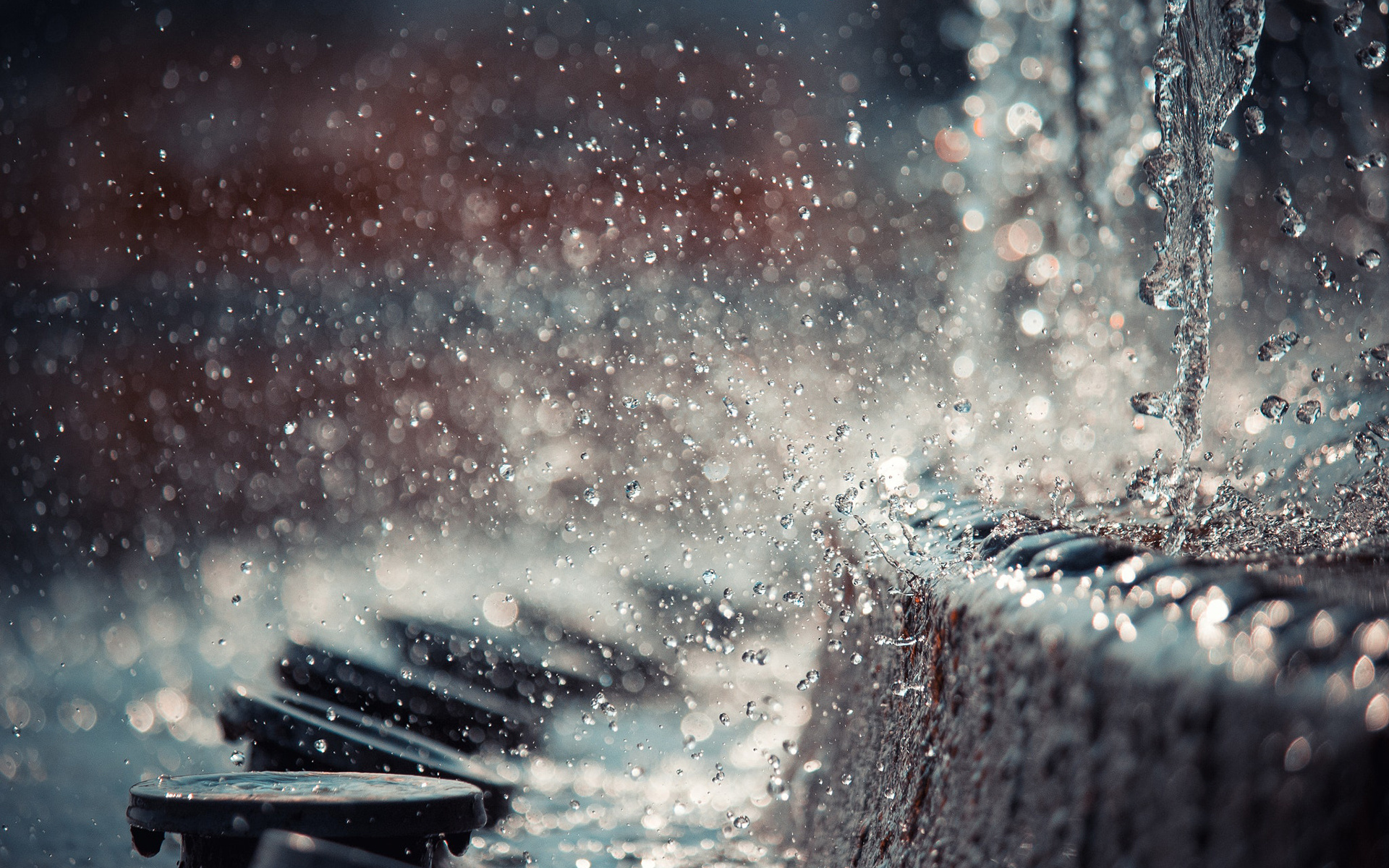 Water drops splashing on a textured surface HD Wallpaper