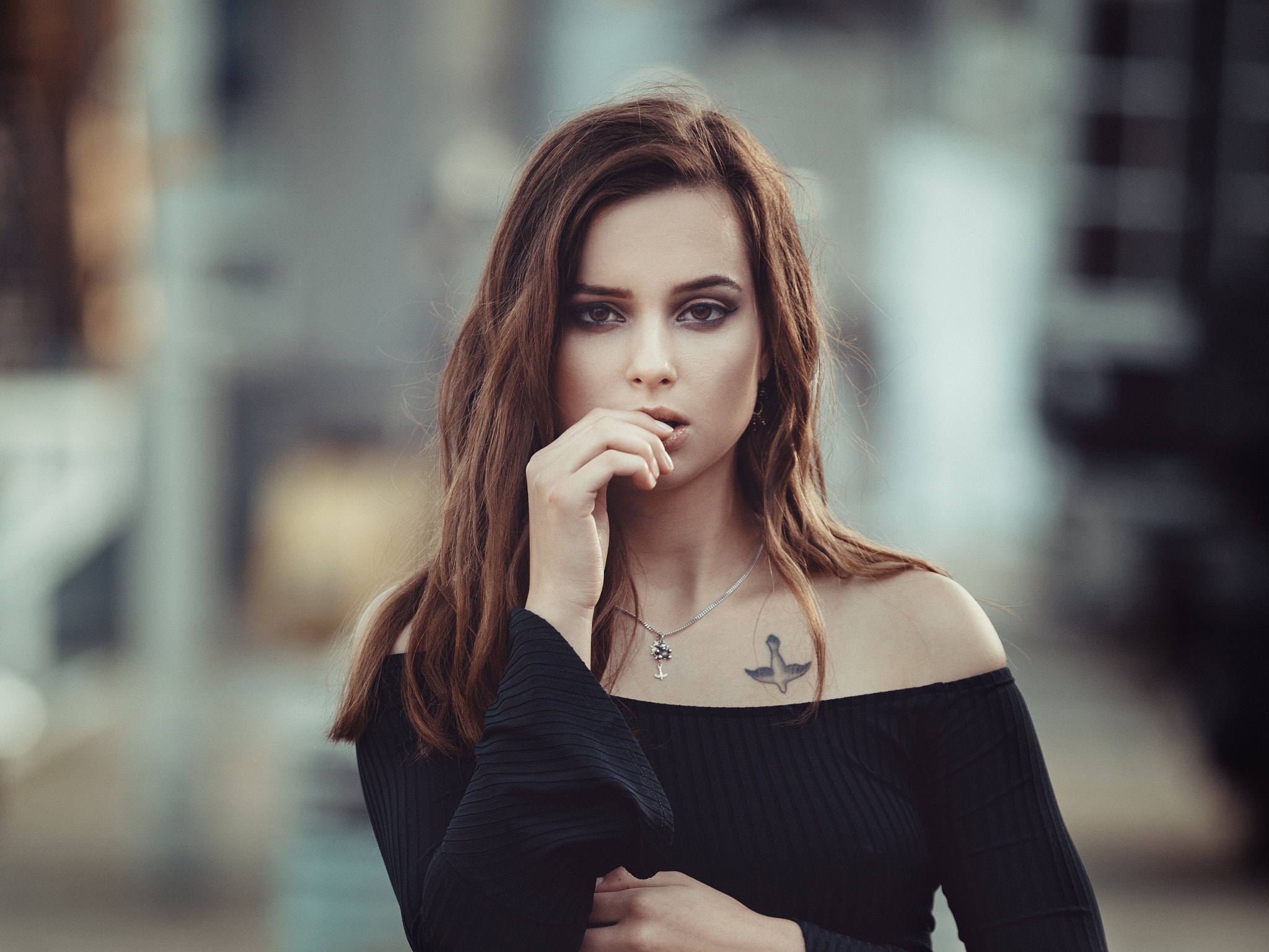 Woman with tattoo and necklace, finger on lips HD Wallpaper