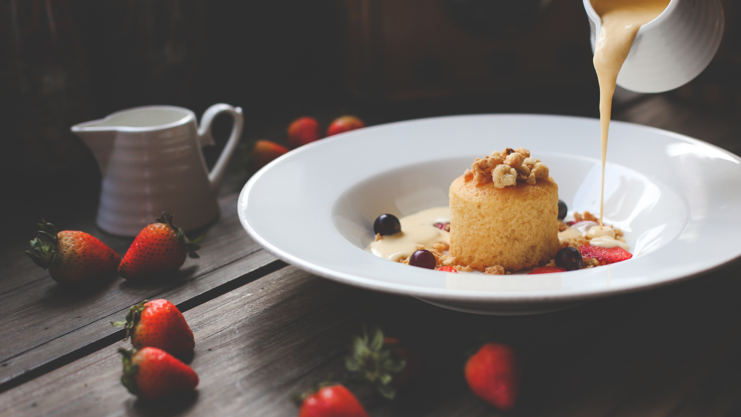Dessert with strawberries and cream poured from a pitcher HD Wallpaper