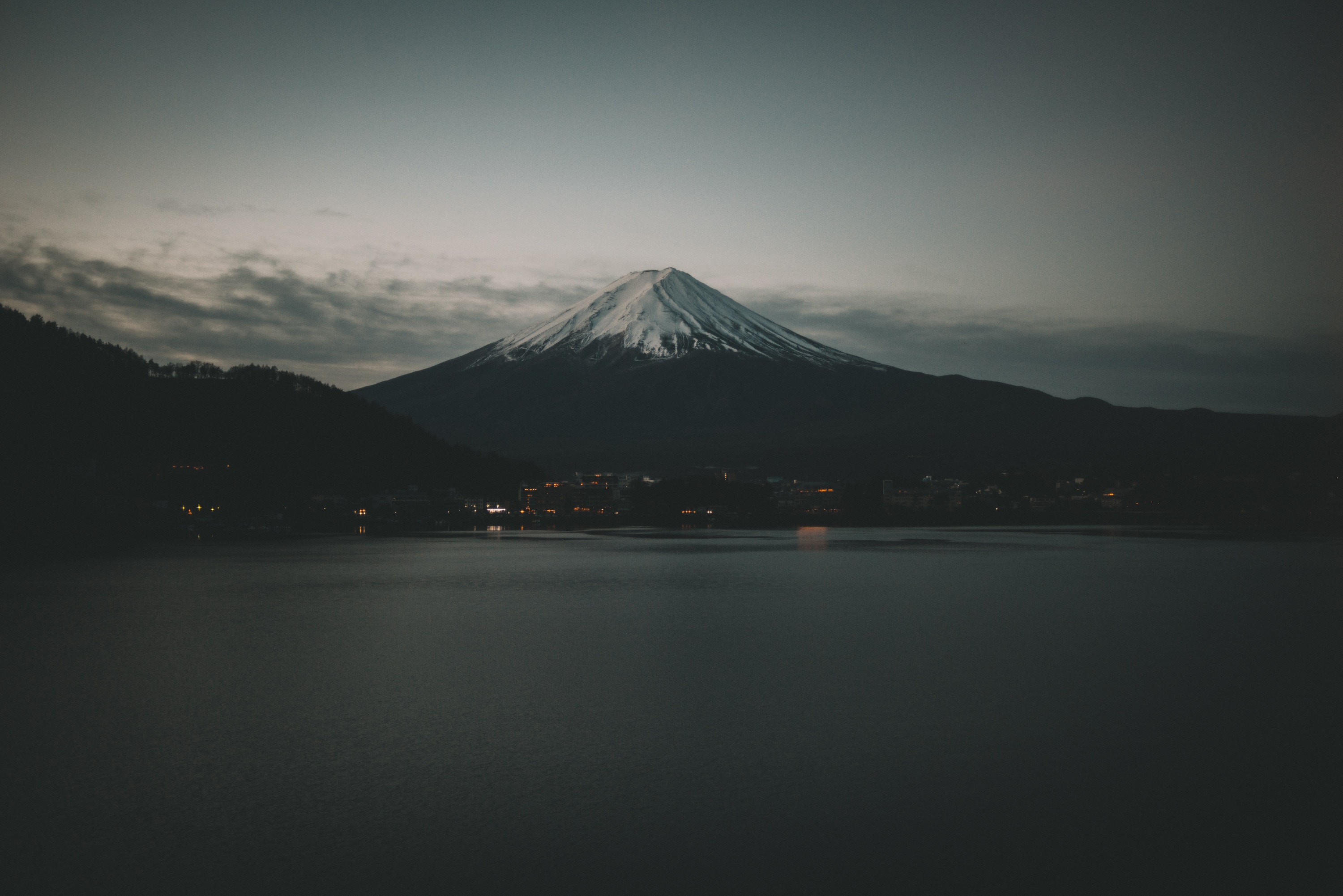 Mount Fuji with snow cap over a lake at dusk HD Wallpaper