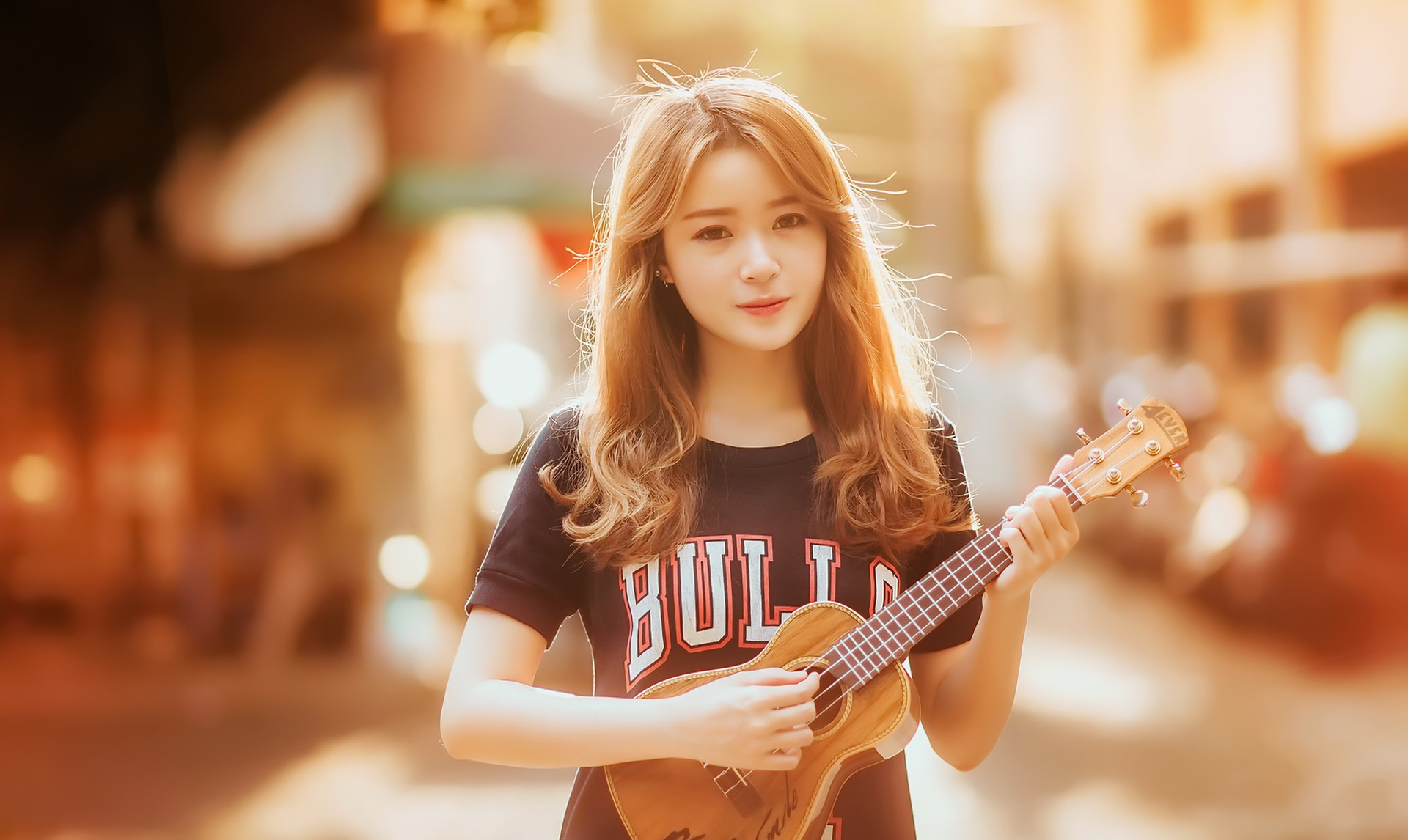 Young Asian woman playing ukulele outdoors HD Wallpaper