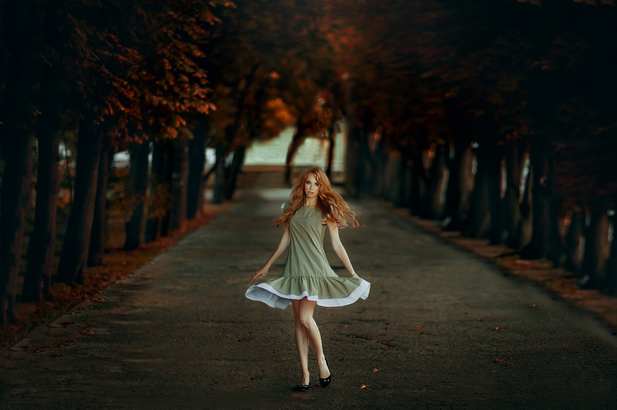 Roma Zhyla in a green dress on a tree-lined path HD Wallpaper