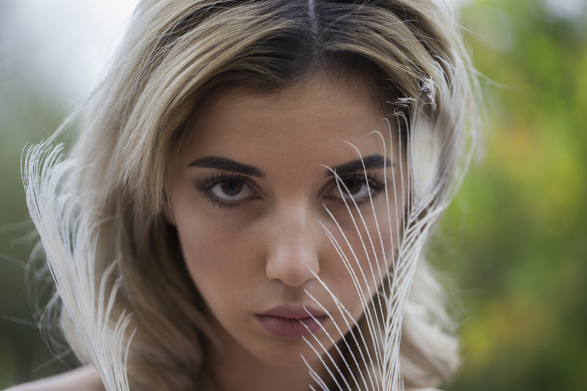 Woman with blonde hair and feather HD Wallpaper