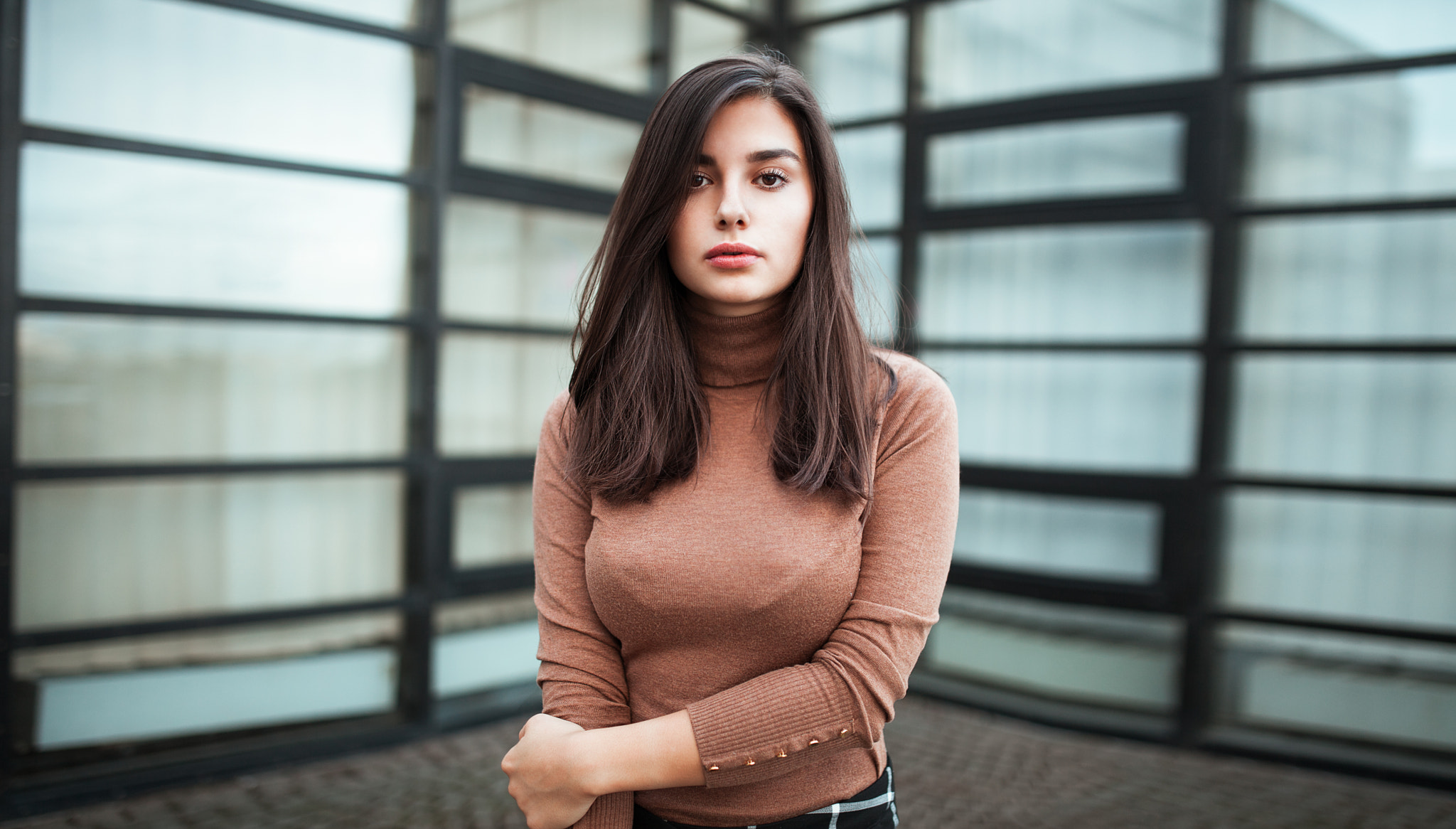 Woman in a turtleneck standing in front of windows HD Wallpaper