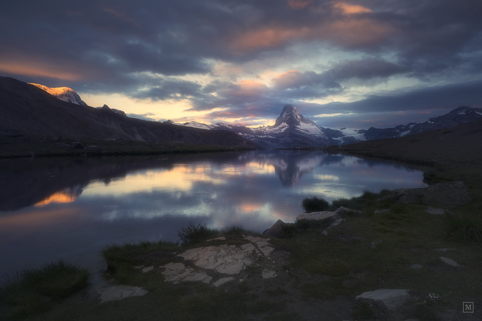 Matterhorn mountain reflected in a lake at sunset HD Wallpaper