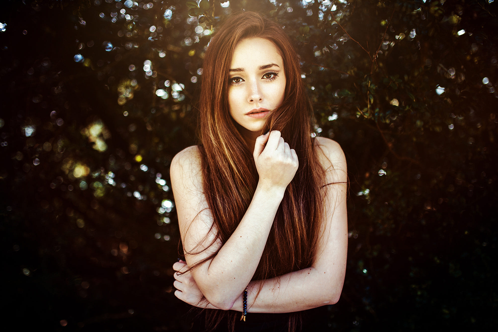 Woman with long brown hair in a forest HD Wallpaper
