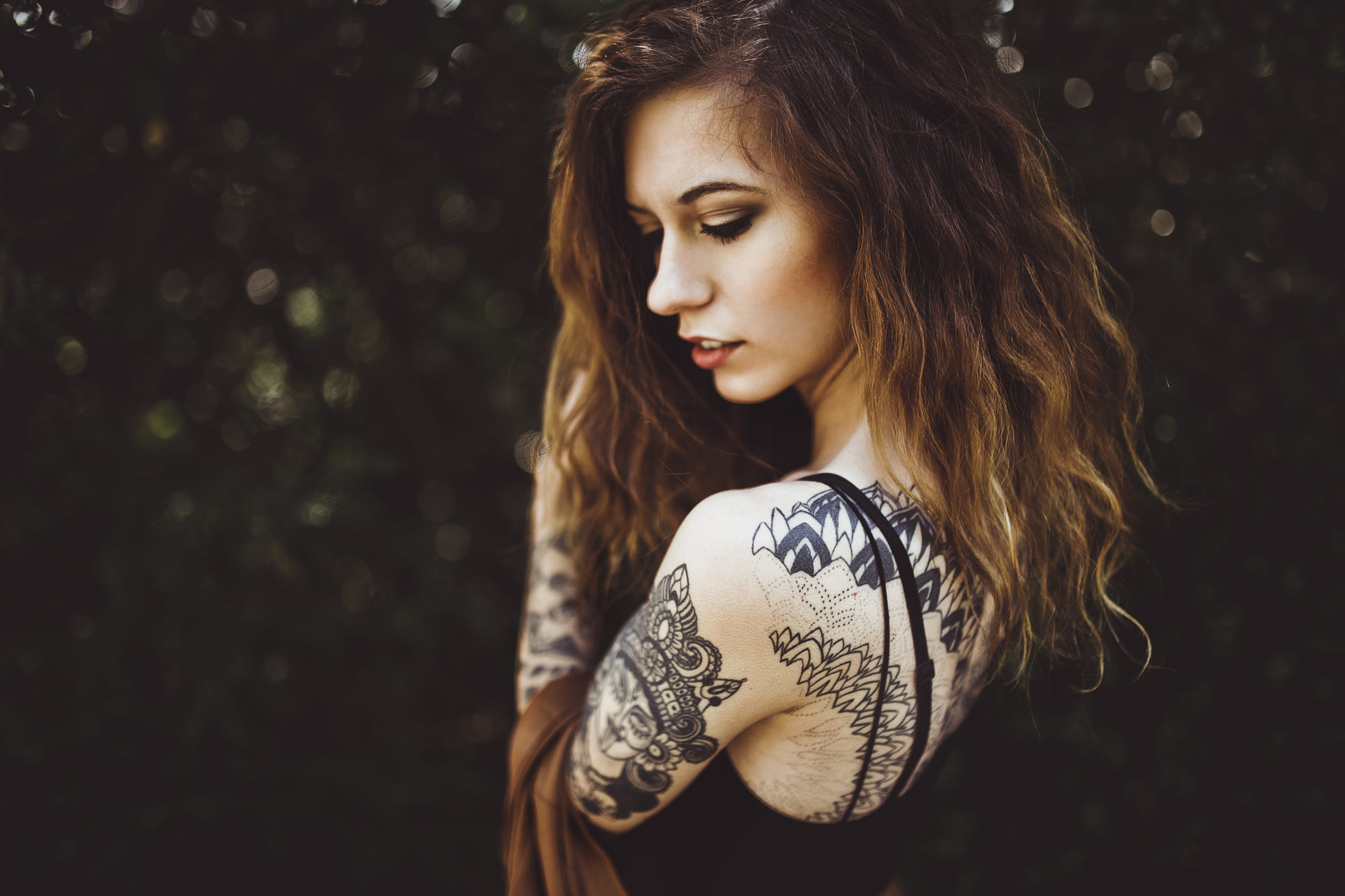 Woman with tattoos in a forest HD Wallpaper