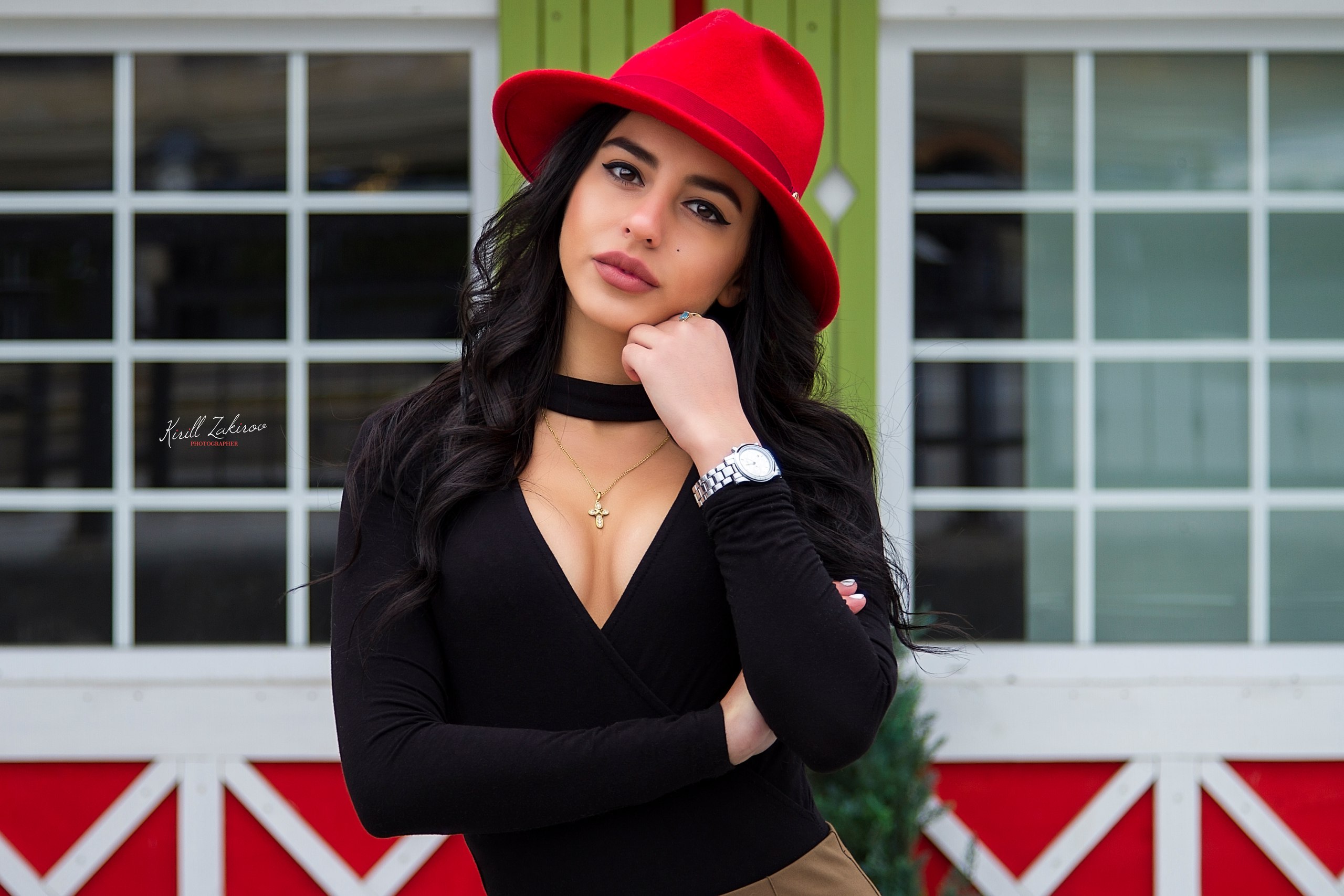 Woman wearing a red hat and black top outdoors HD Wallpaper