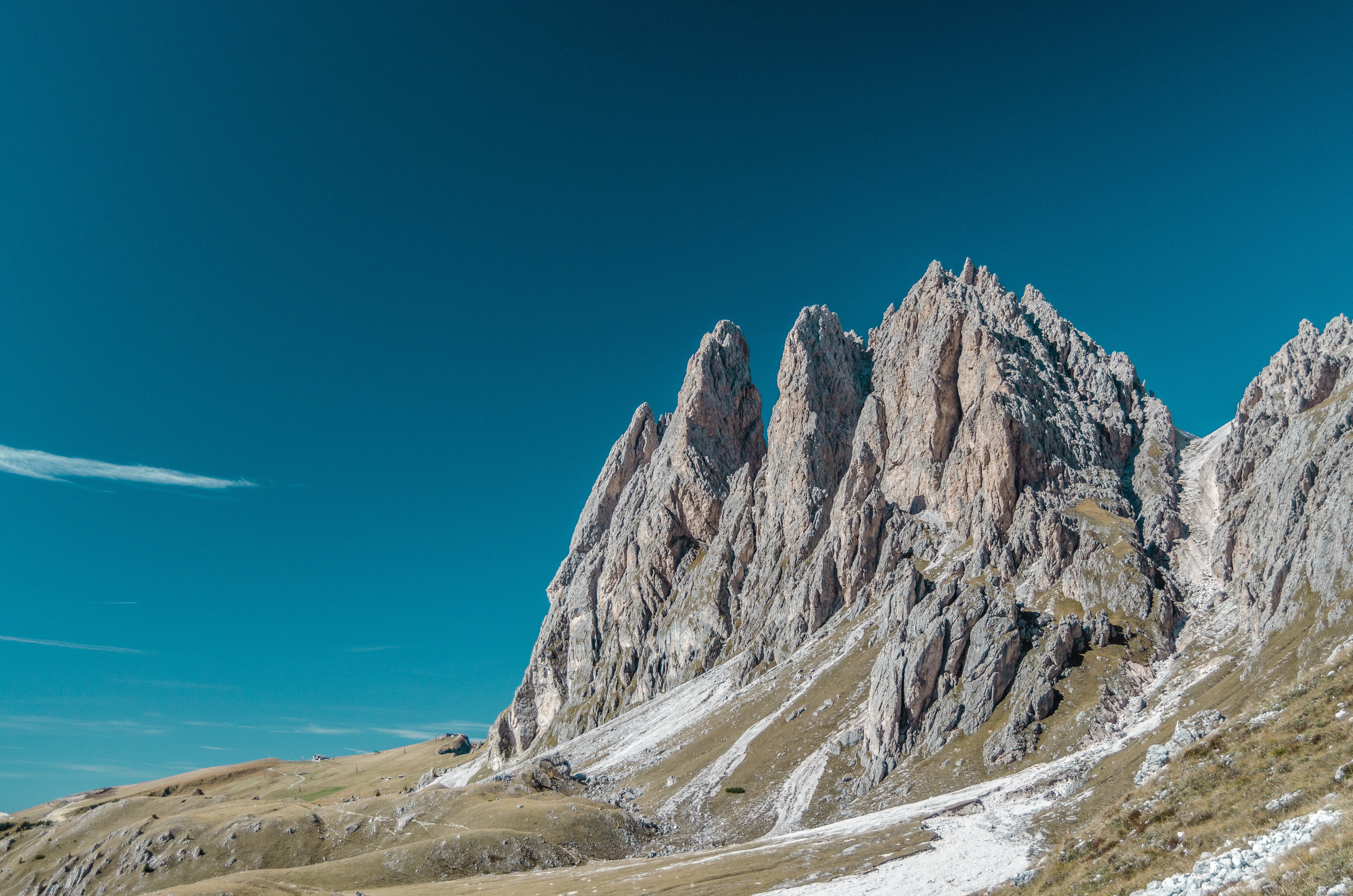 Jagged mountain peaks under a clear blue sky HD Wallpaper
