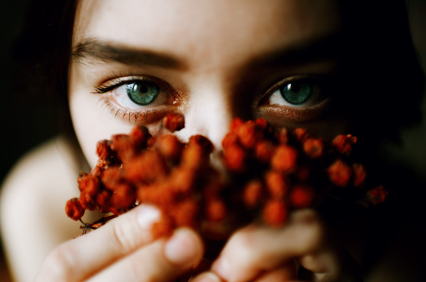 Woman with blue eyes holding red berries HD Wallpaper
