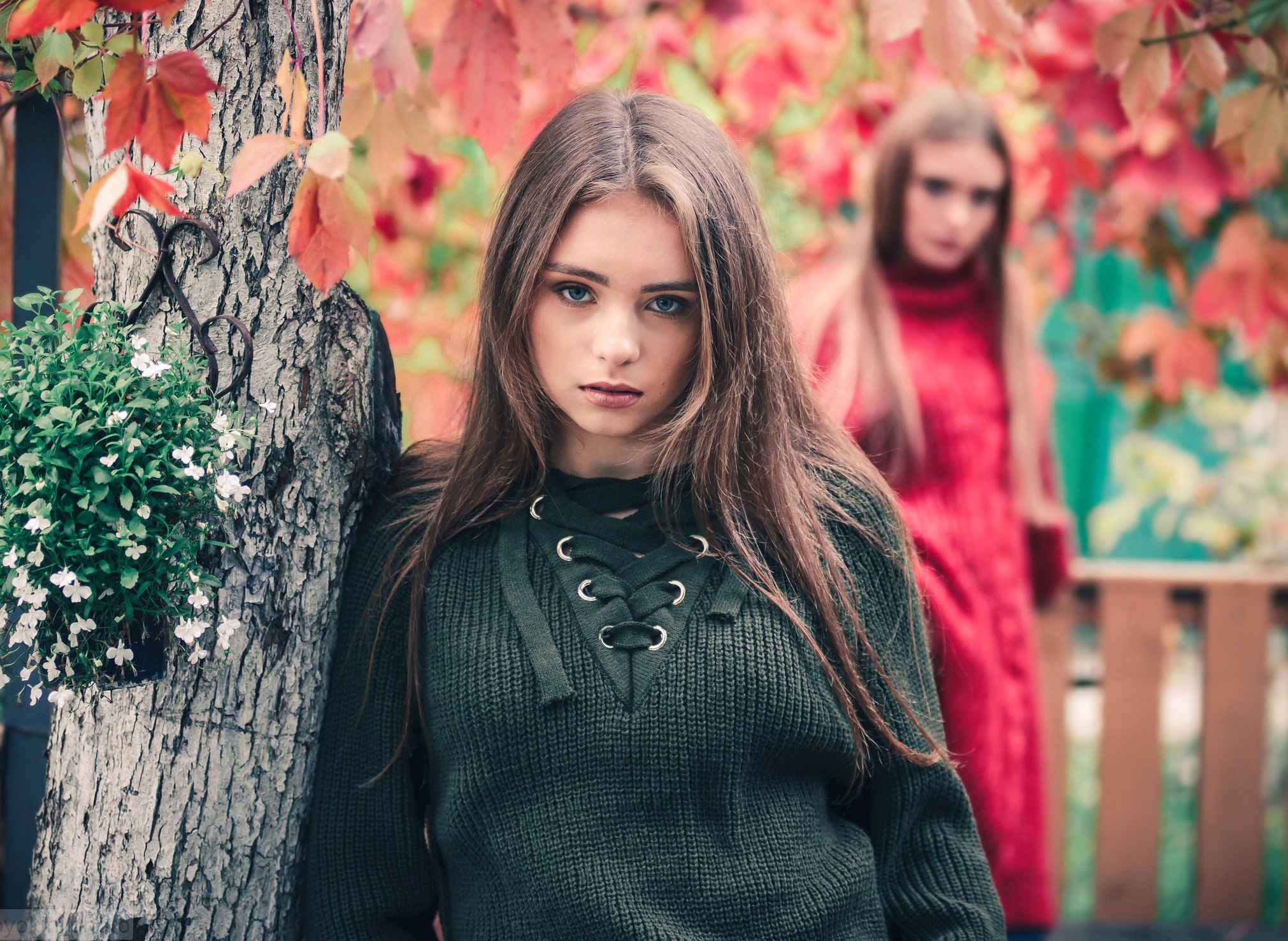 Two women in autumn setting, one in foreground HD Wallpaper