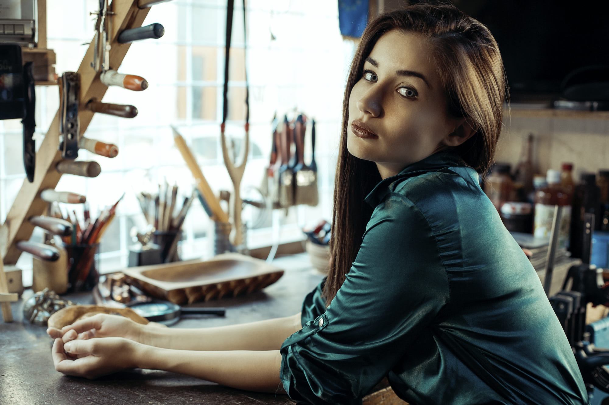 Woman with long brown hair in a workshop HD Wallpaper