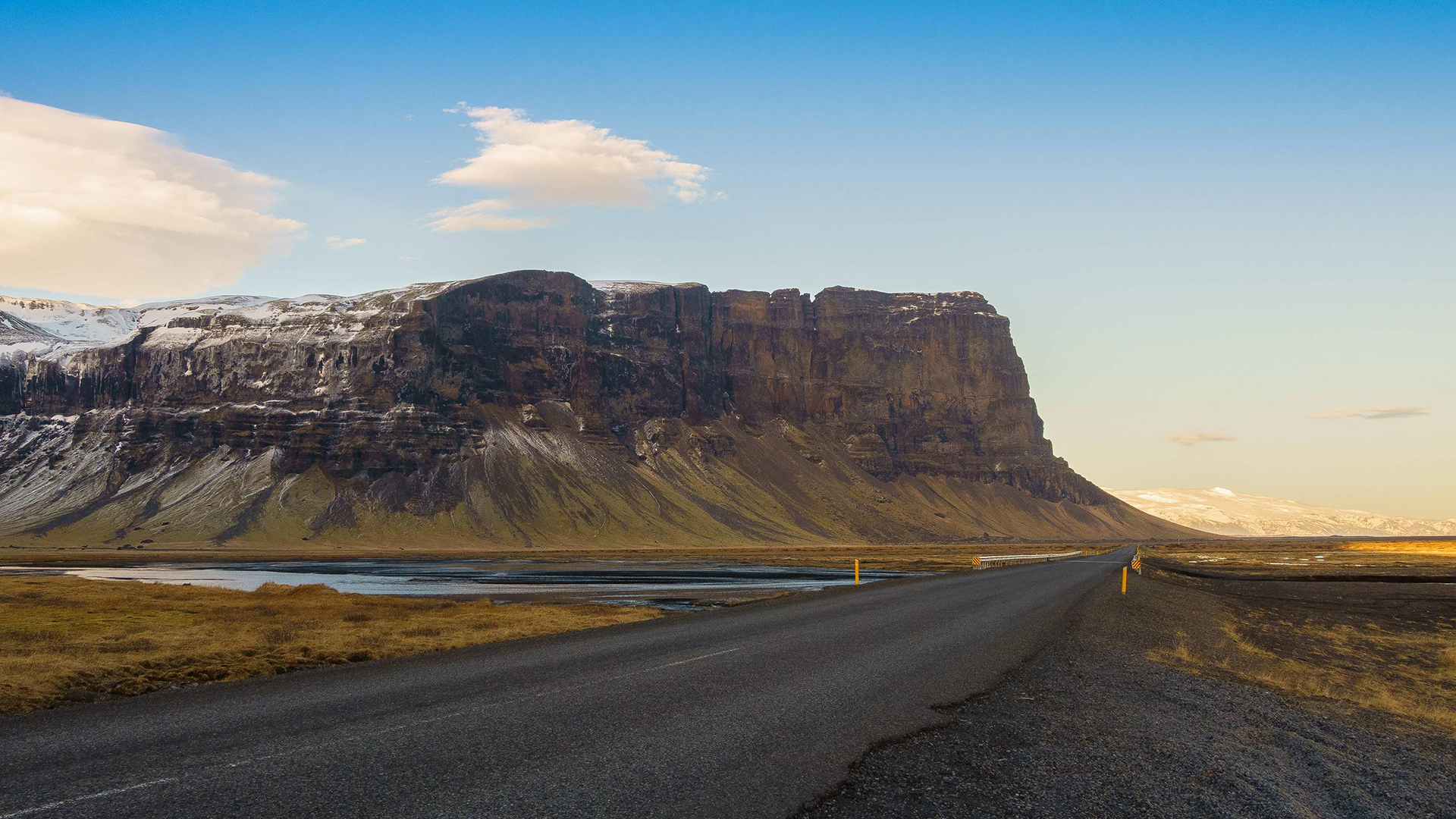 Road leading to a large mountain range HD Wallpaper