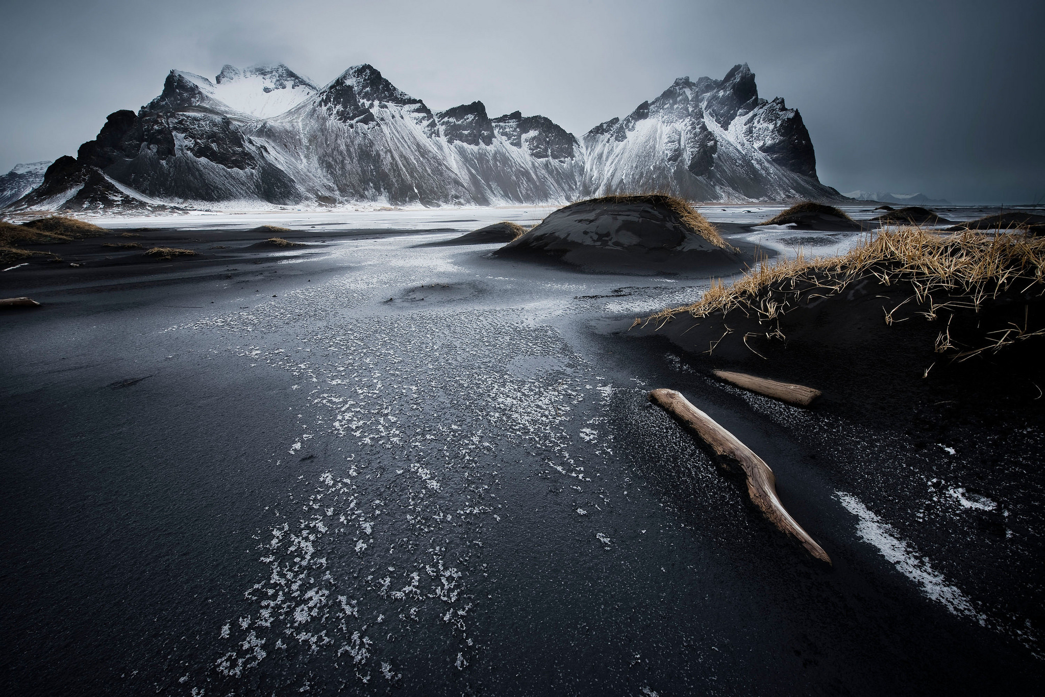 Snow-capped mountains and black sand beach in Iceland HD Wallpaper
