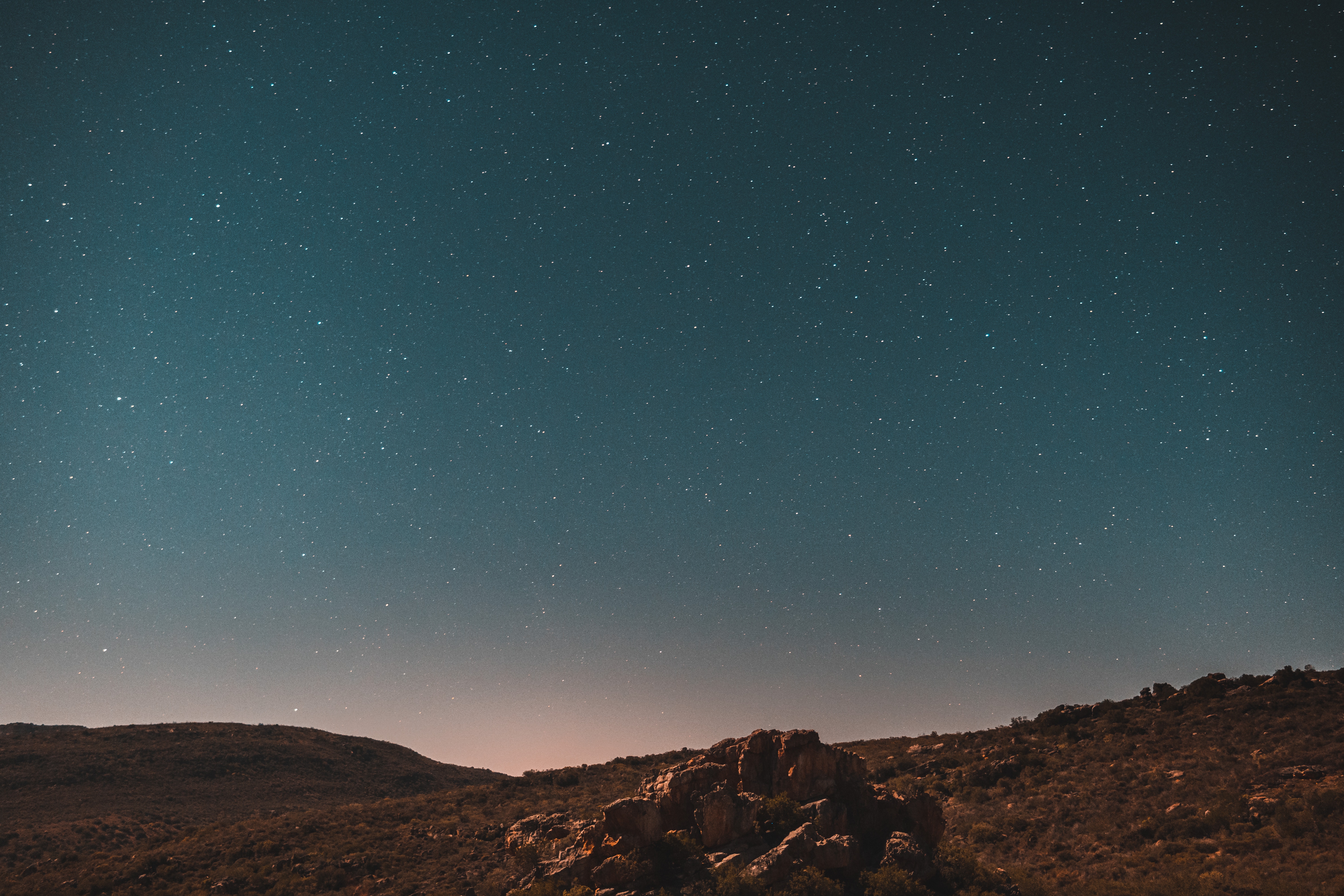 Starry night sky over desert rocks HD Wallpaper