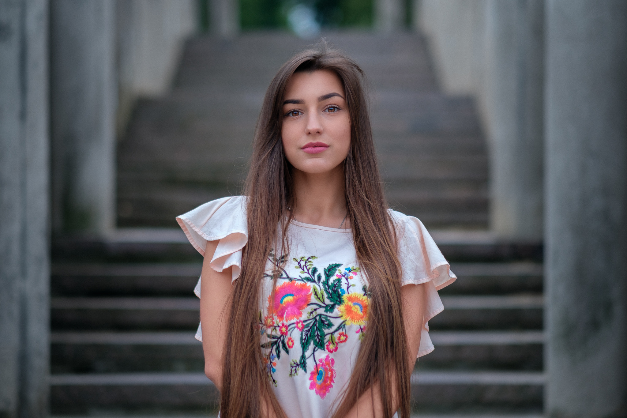 Woman with long hair in embroidered shirt on stairs HD Wallpaper