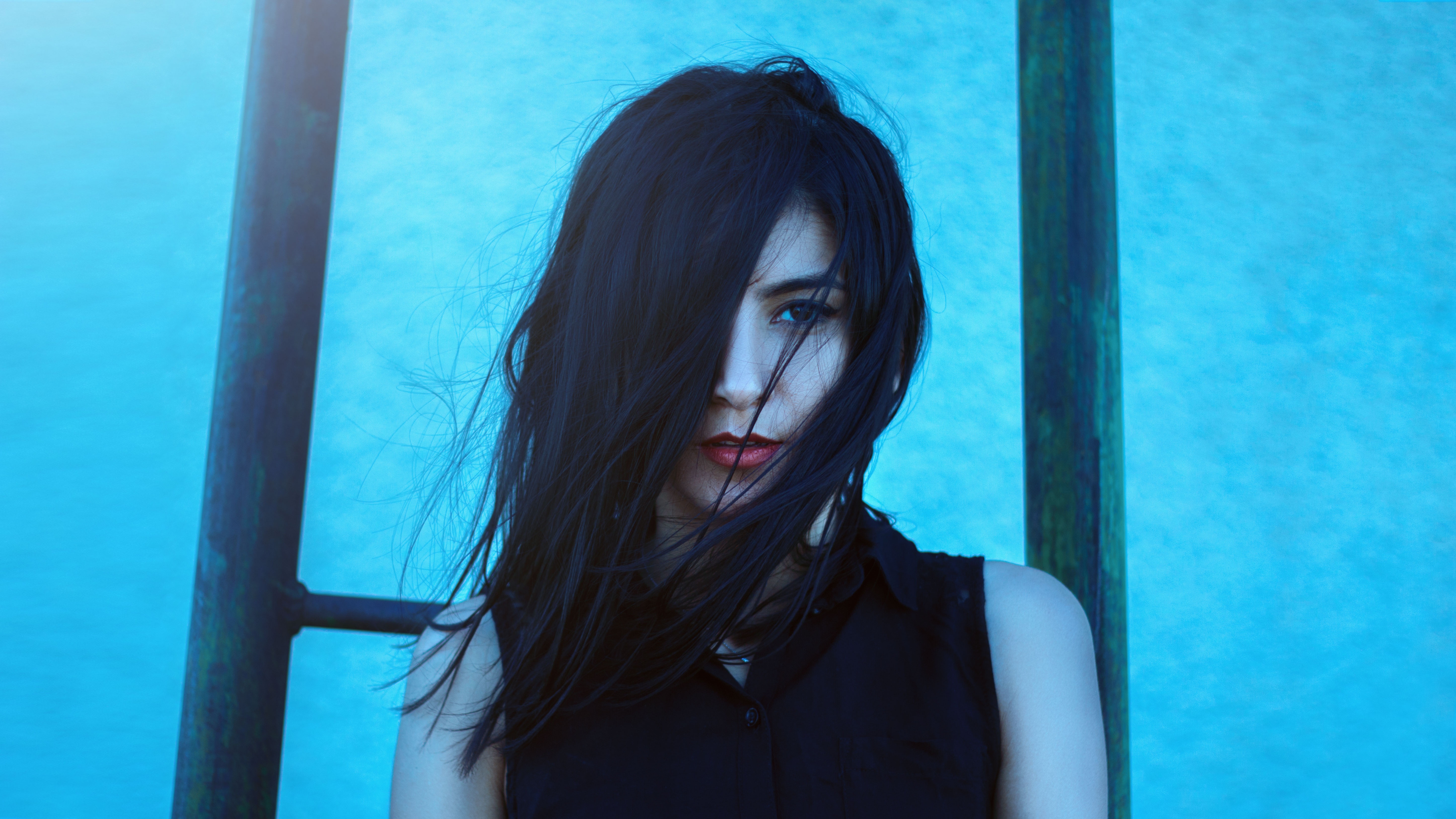 Woman with dark hair in black outfit outdoors HD Wallpaper