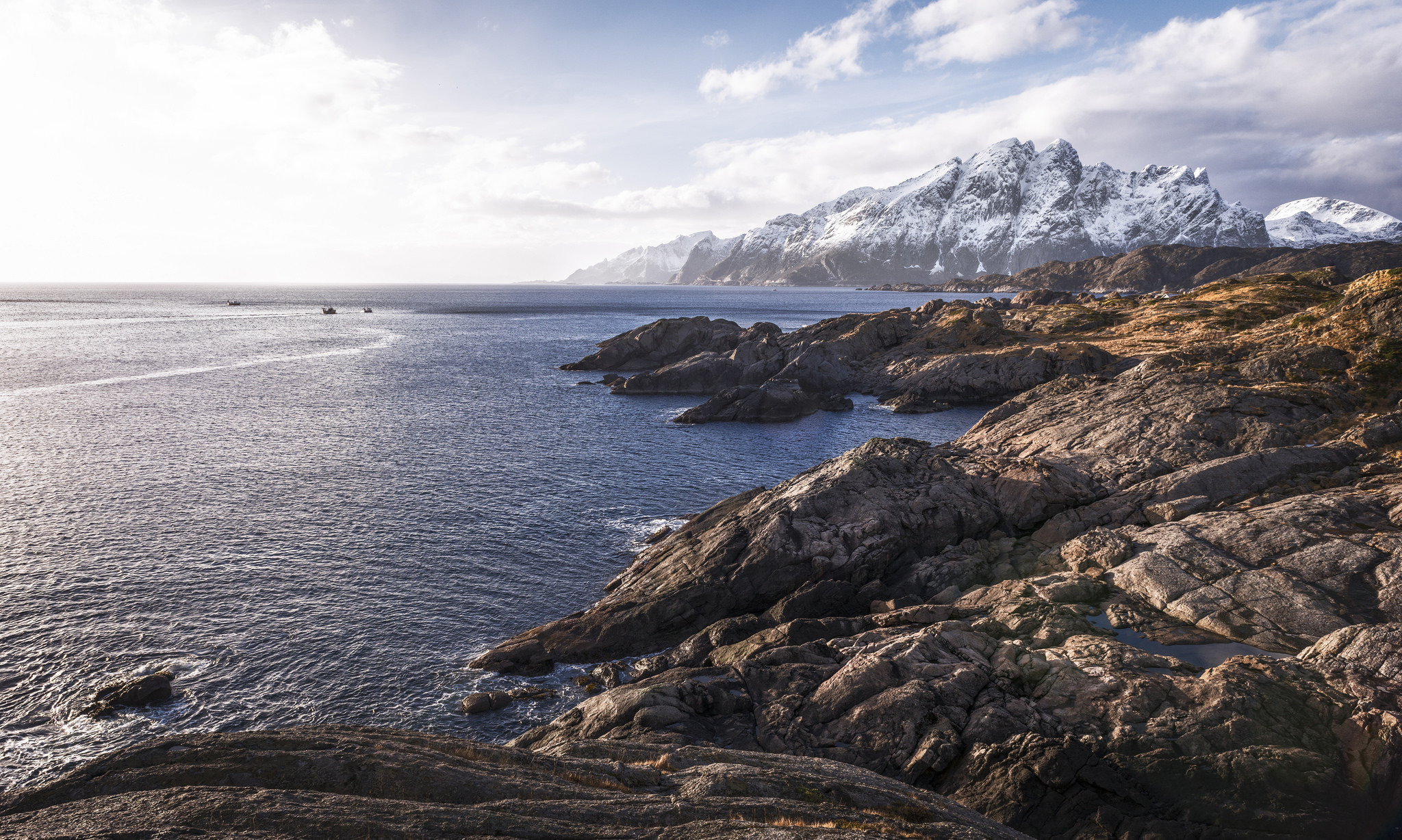Rocky Coastline with Snow-Capped Mountains in Norway HD Wallpaper
