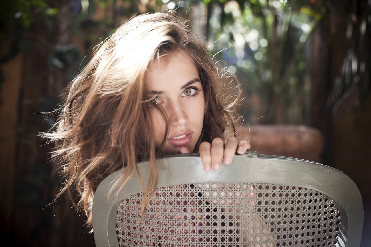 Ana de Armas sitting behind a chair HD Wallpaper