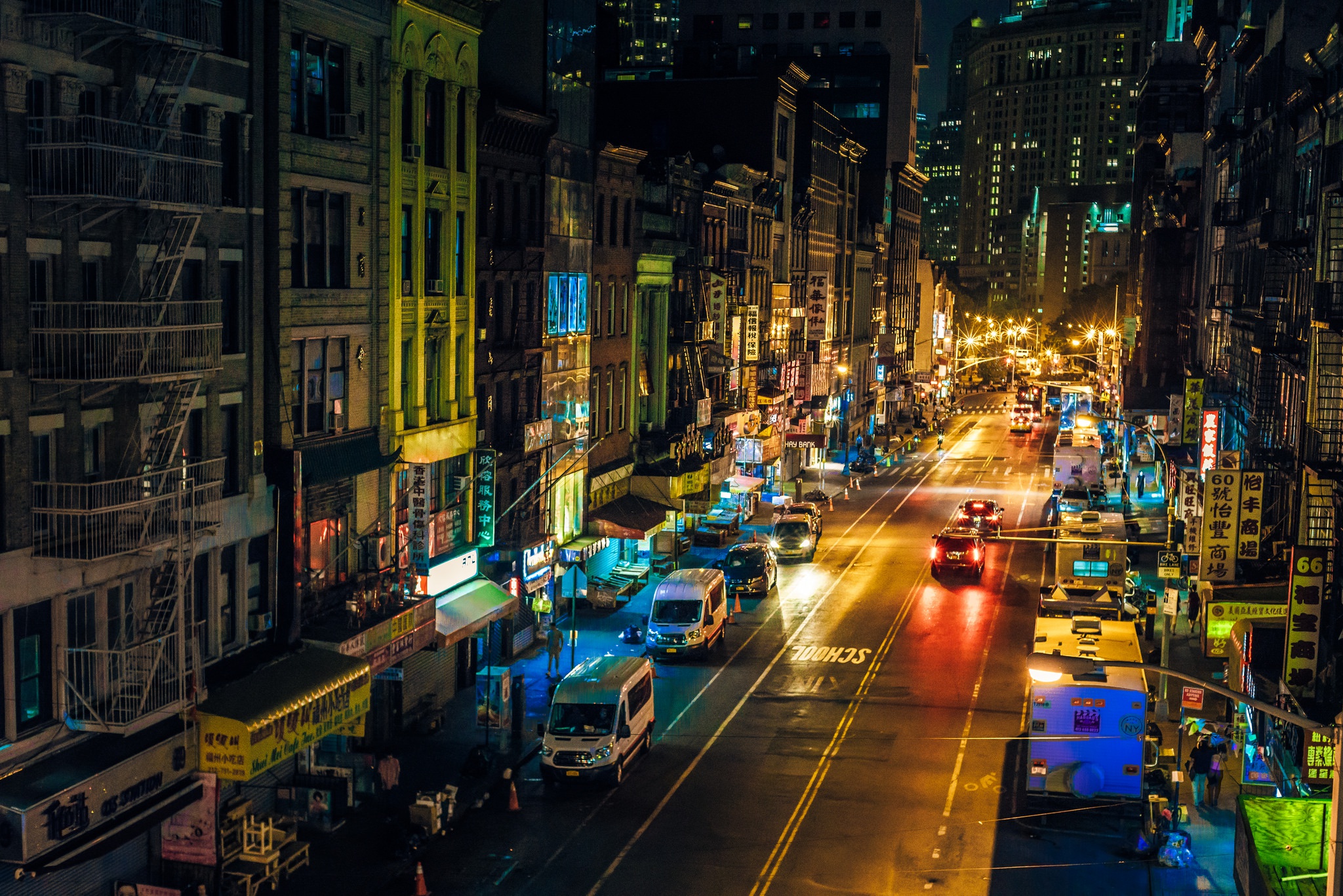 Nighttime street scene in Manhattan with traffic and illuminated buildings HD Wallpaper