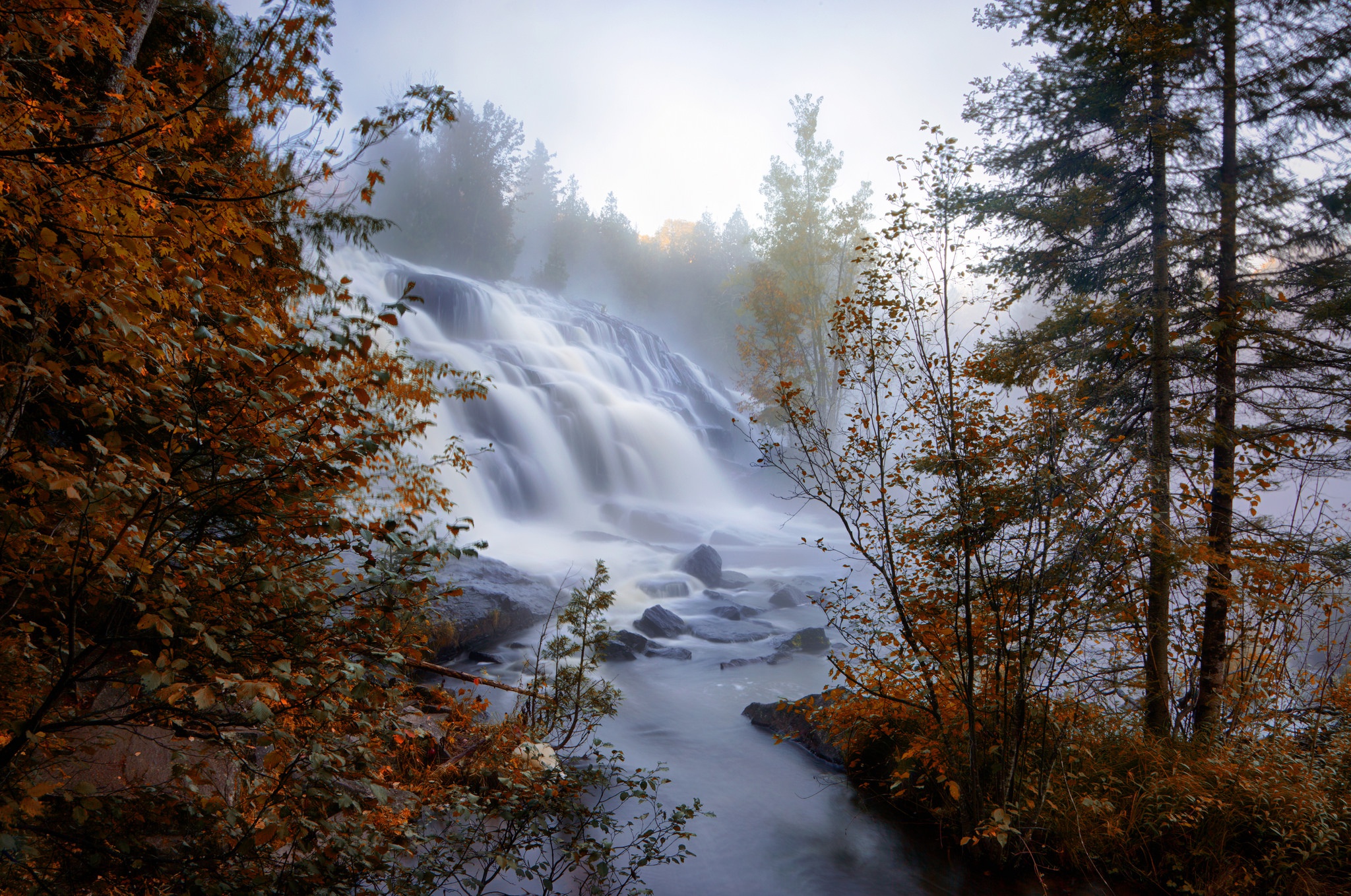 Waterfall in autumn with trees and mist HD Wallpaper