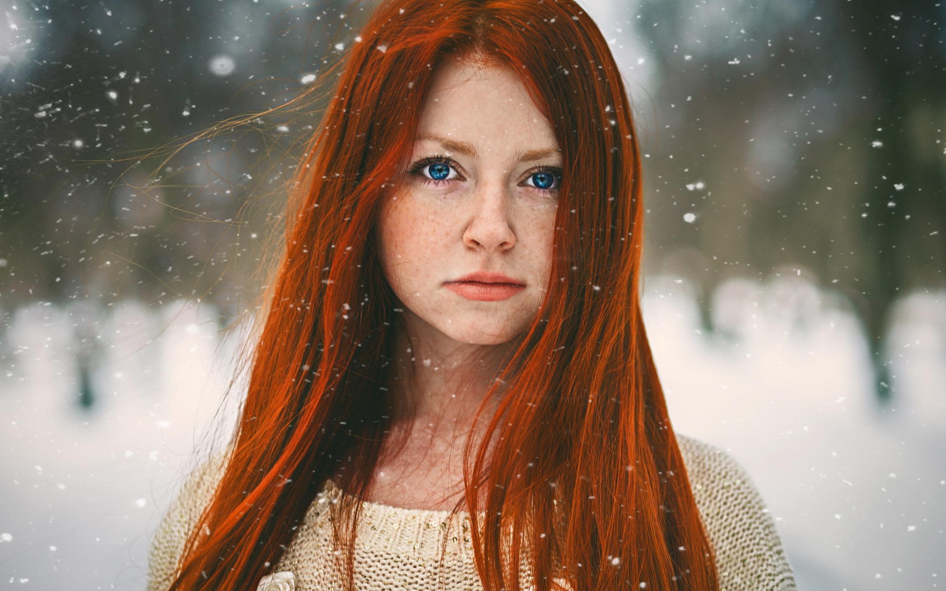 Redhead woman with blue eyes in the snow HD Wallpaper