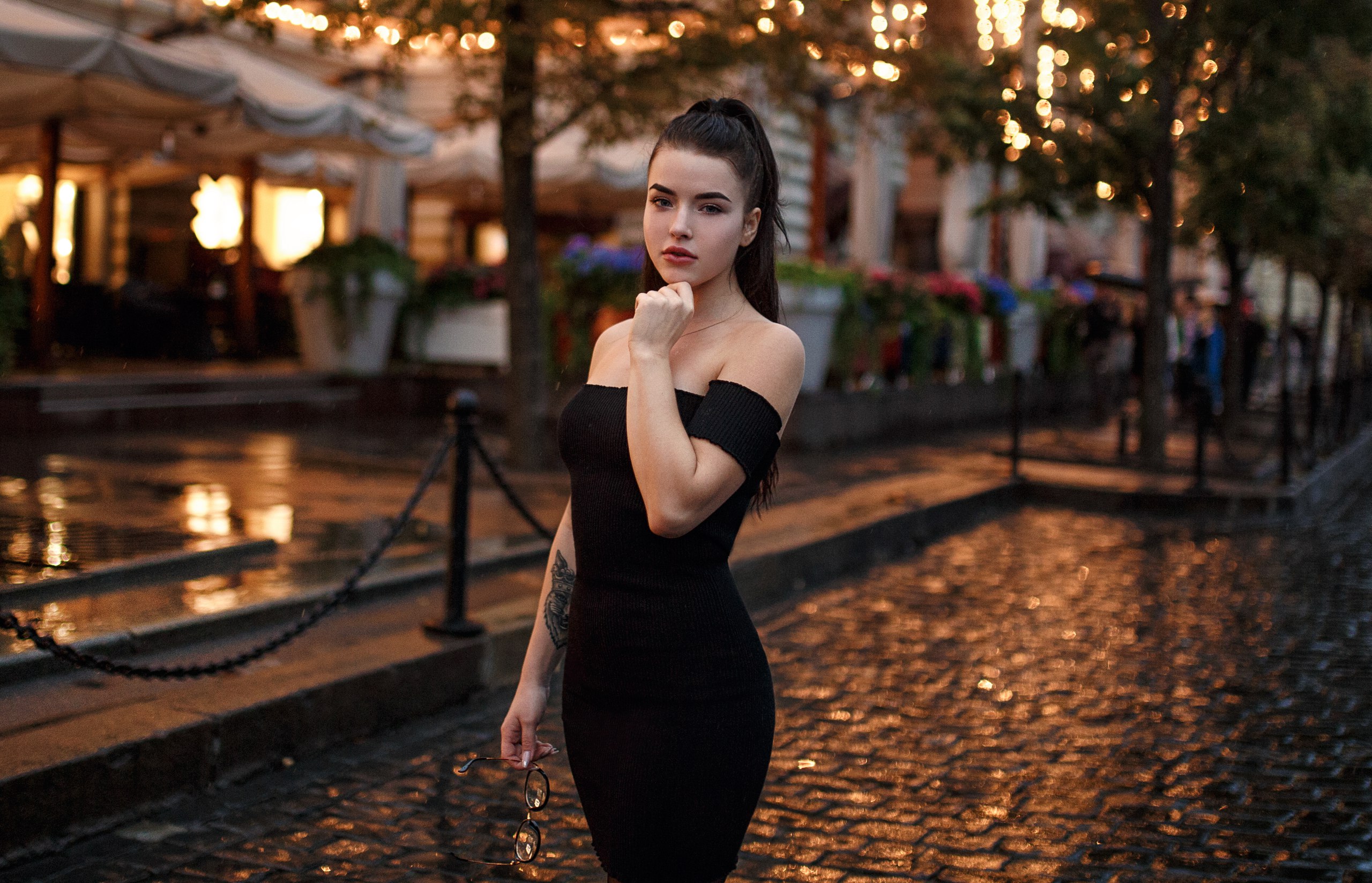 Woman in black dress holding glasses outdoors HD Wallpaper