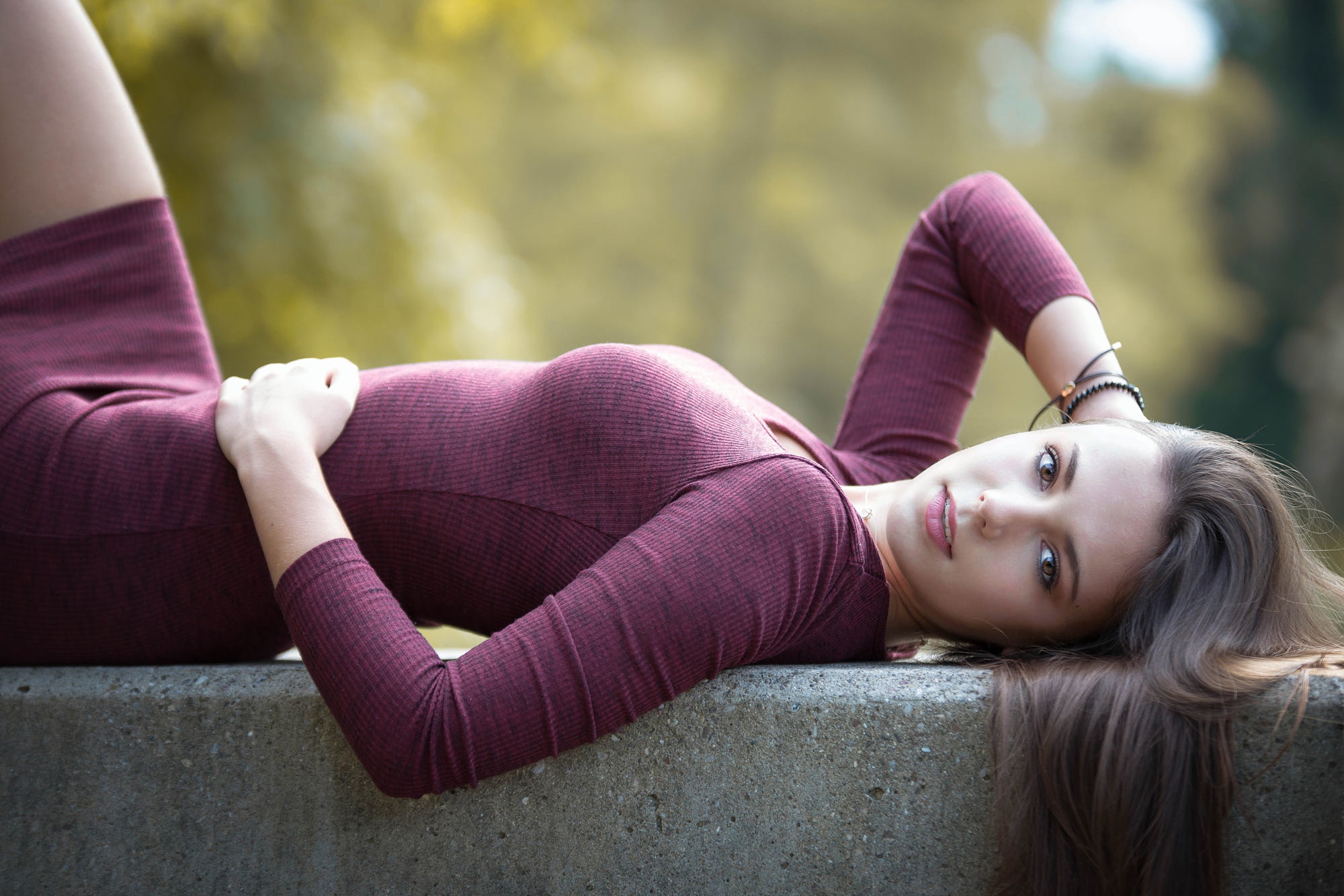 Woman lying on concrete outdoors HD Wallpaper