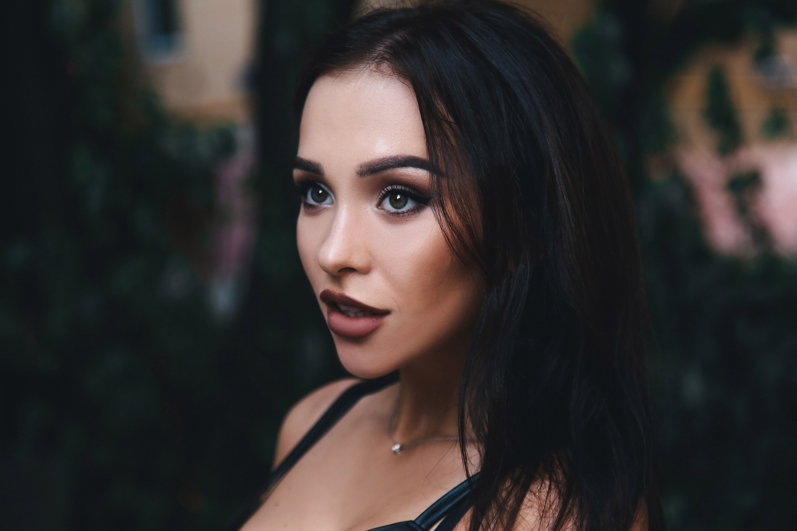 Woman with dark hair wearing a necklace HD Wallpaper