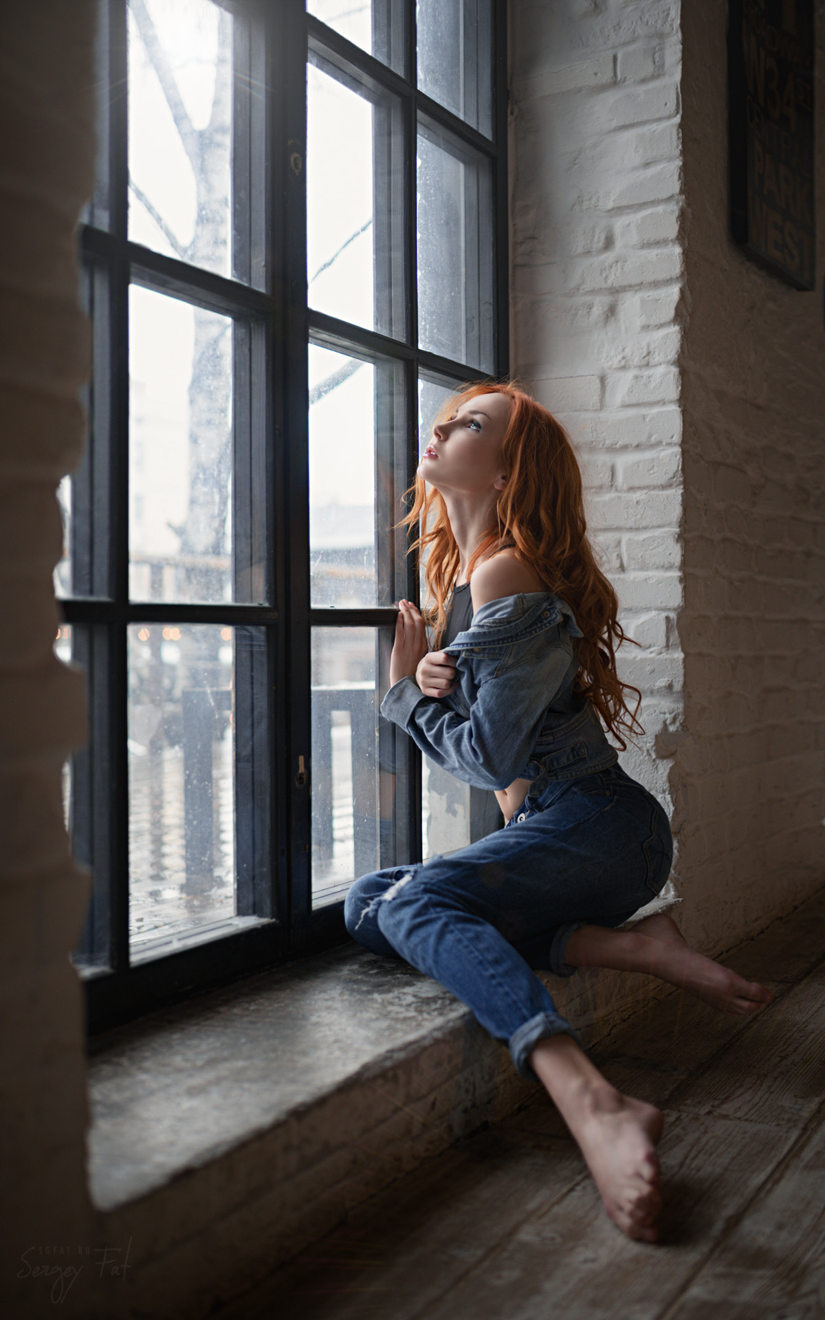 Redhead woman in denim sitting by a window HD Wallpaper