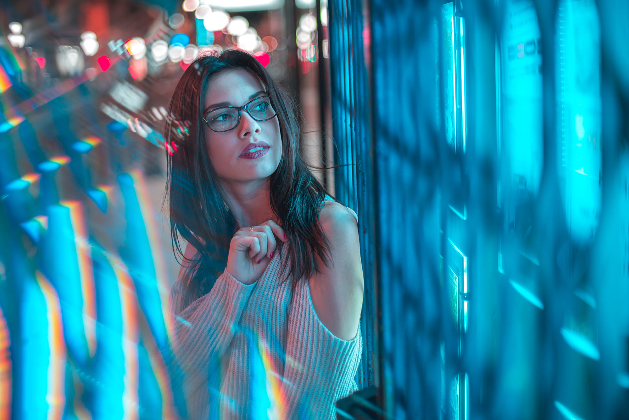 Woman with glasses looking at blue lights HD Wallpaper