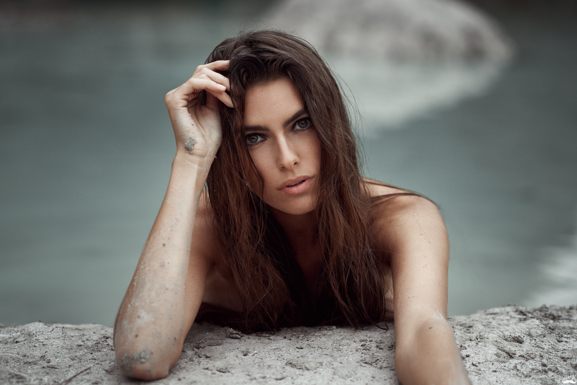 Woman with hand on head by water HD Wallpaper