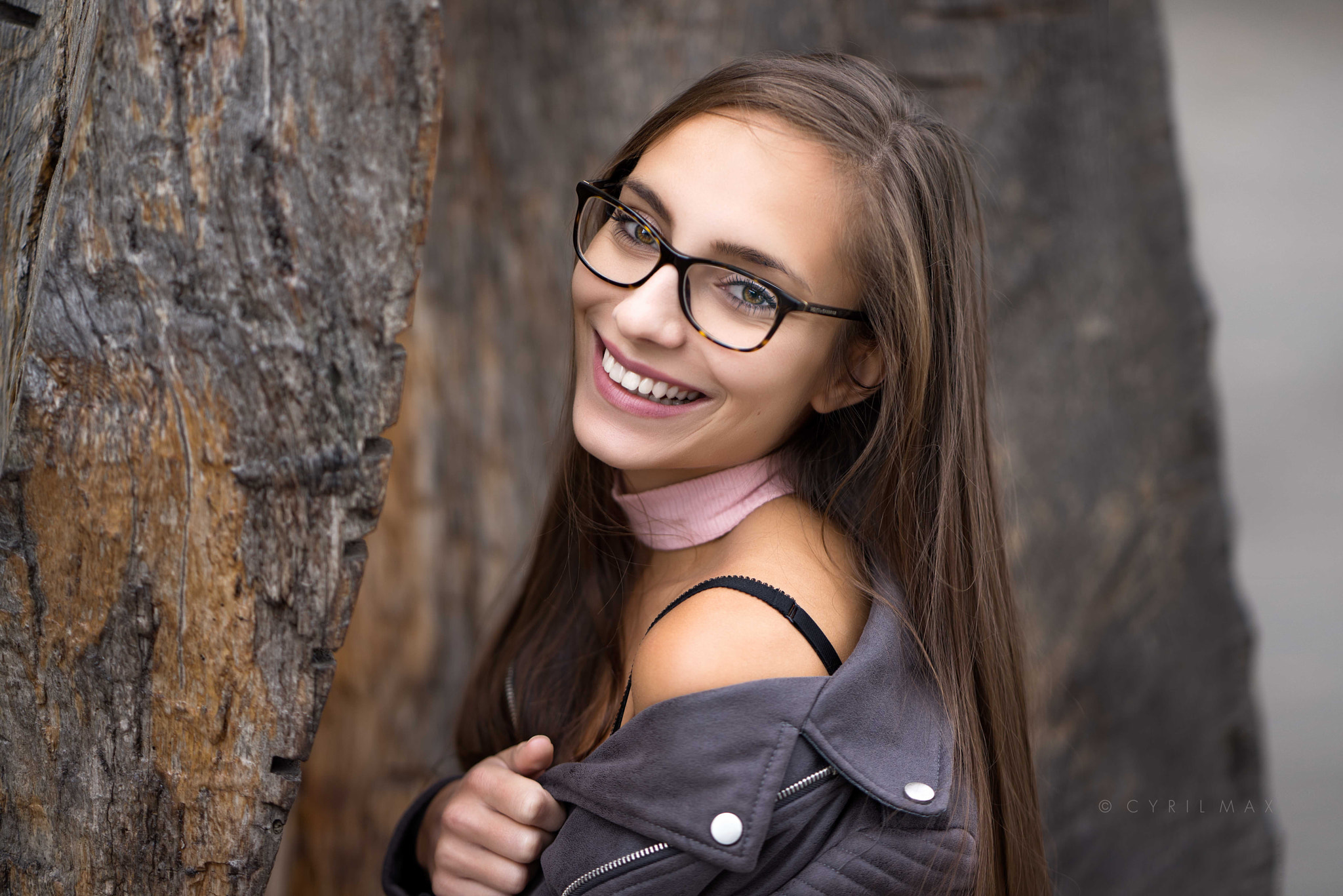 Woman with glasses smiling near a tree HD Wallpaper