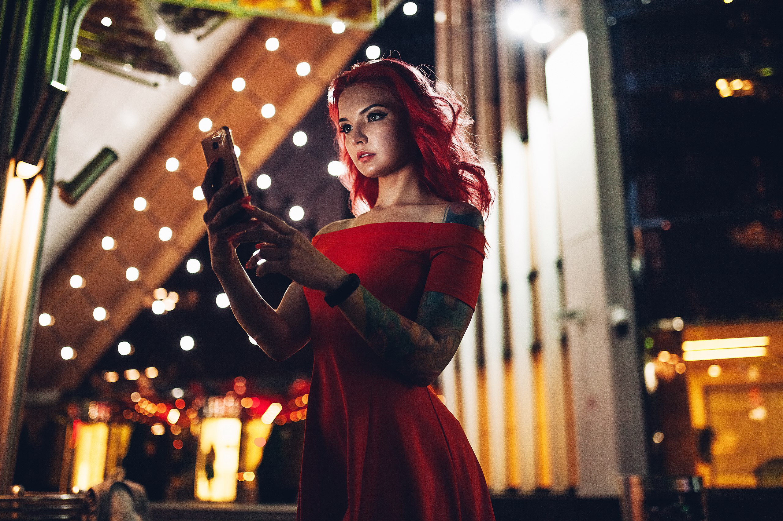 Woman with red hair and tattoos holding a cellphone HD Wallpaper