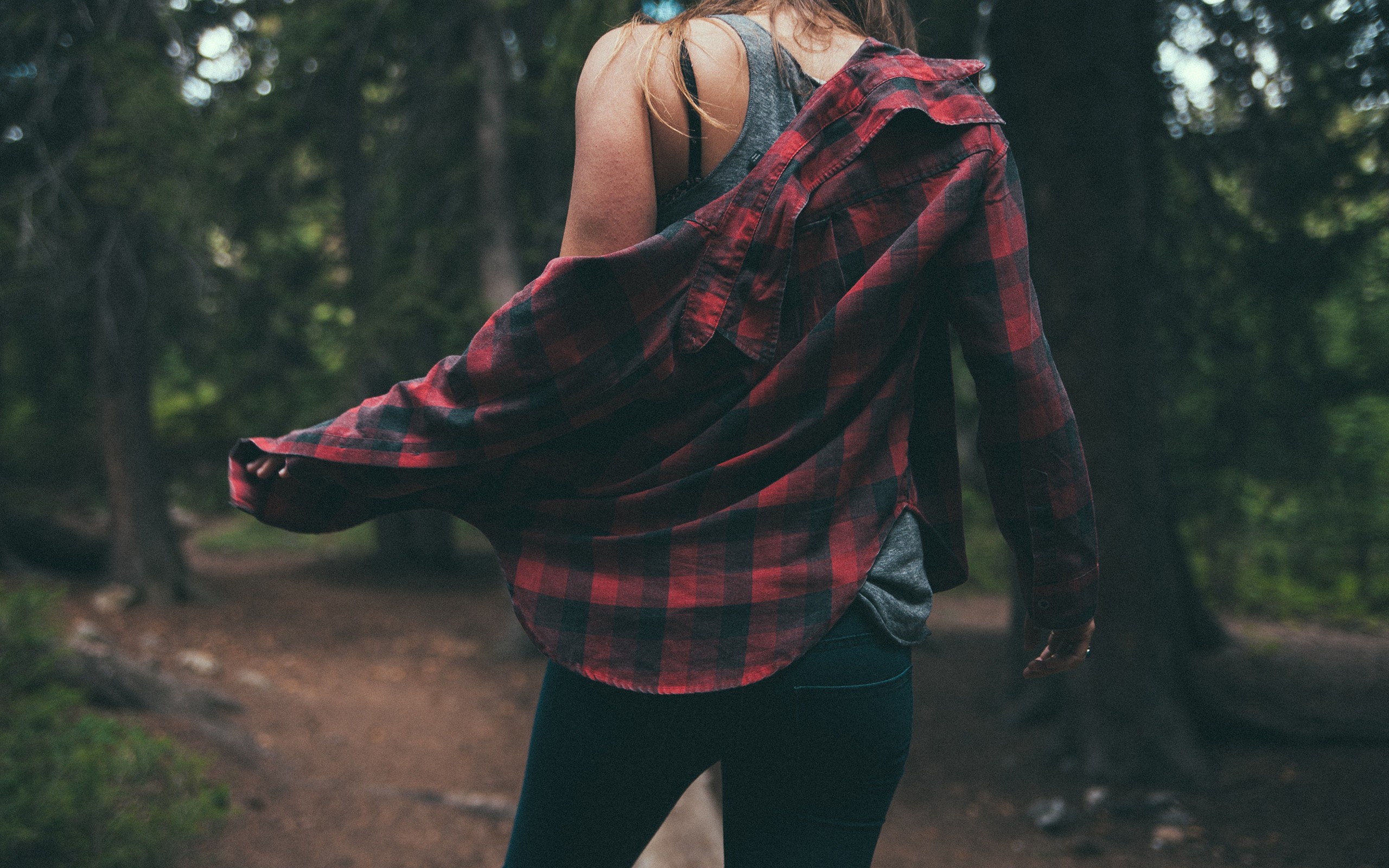 Woman in a red plaid shirt in a forest HD Wallpaper