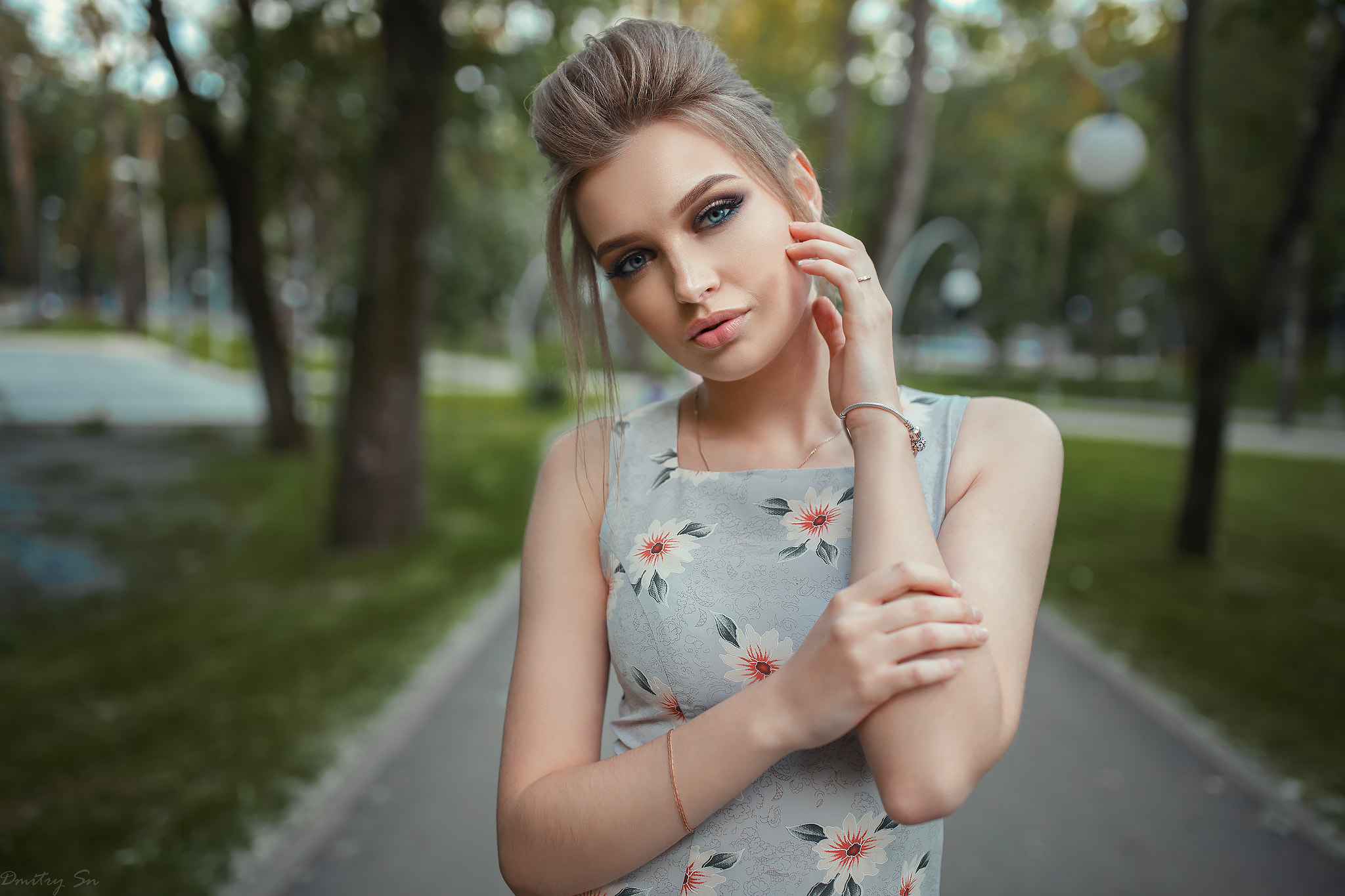 Woman with blonde hair in a floral dress outdoors HD Wallpaper