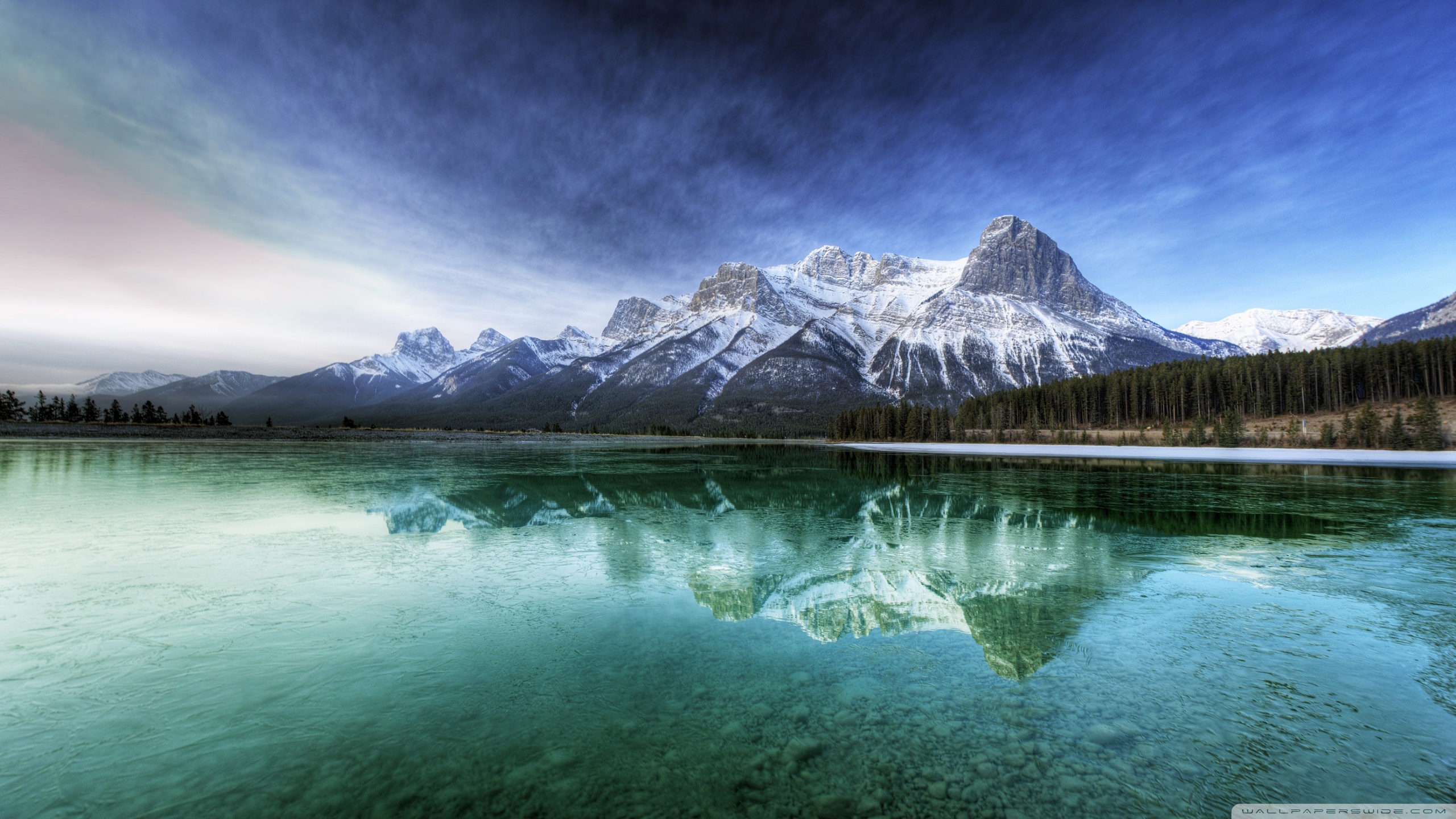 Snow-capped mountains reflected in a clear lake HD Wallpaper